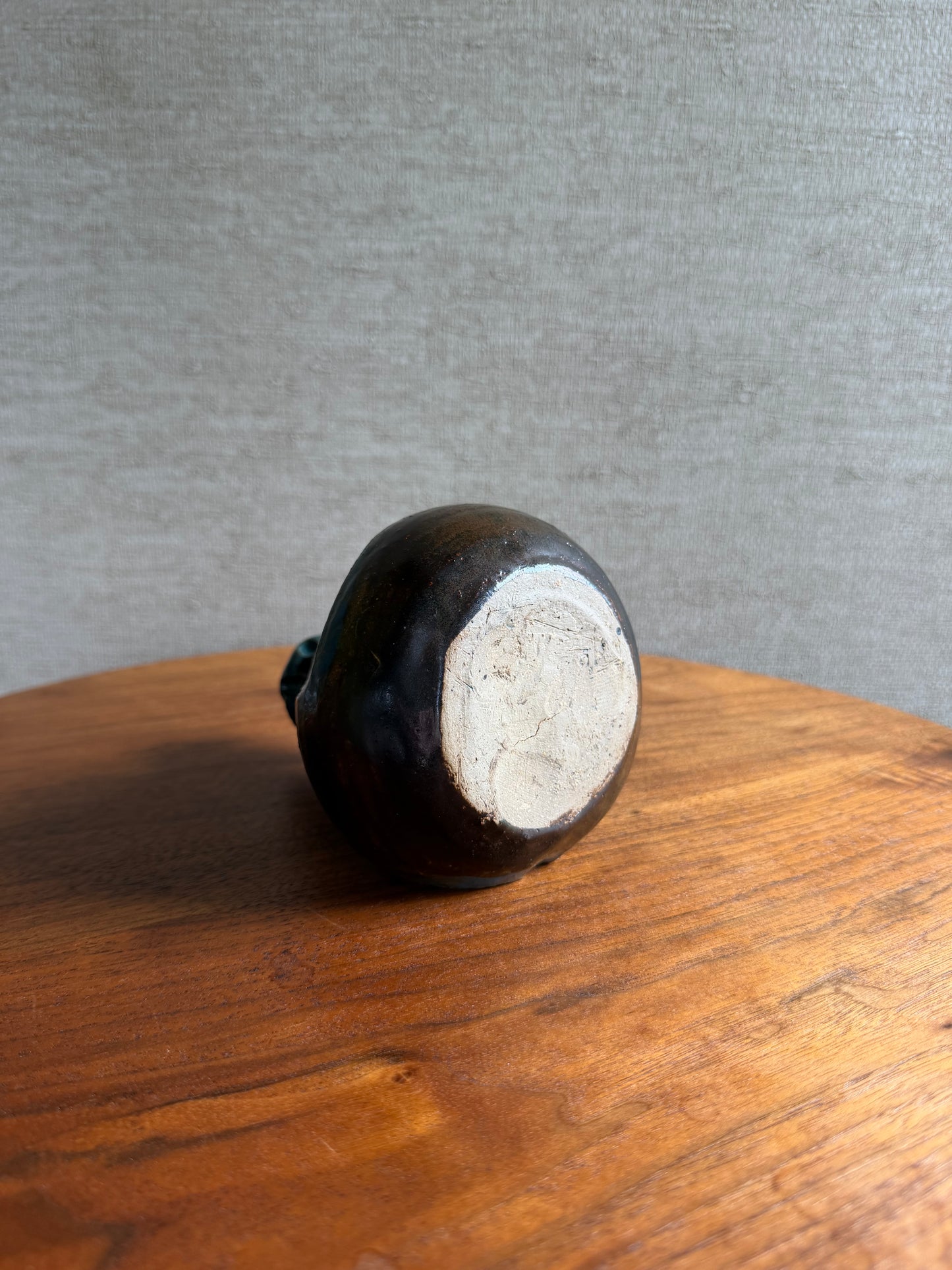 Wooden knob on a wooden surface with a gray background