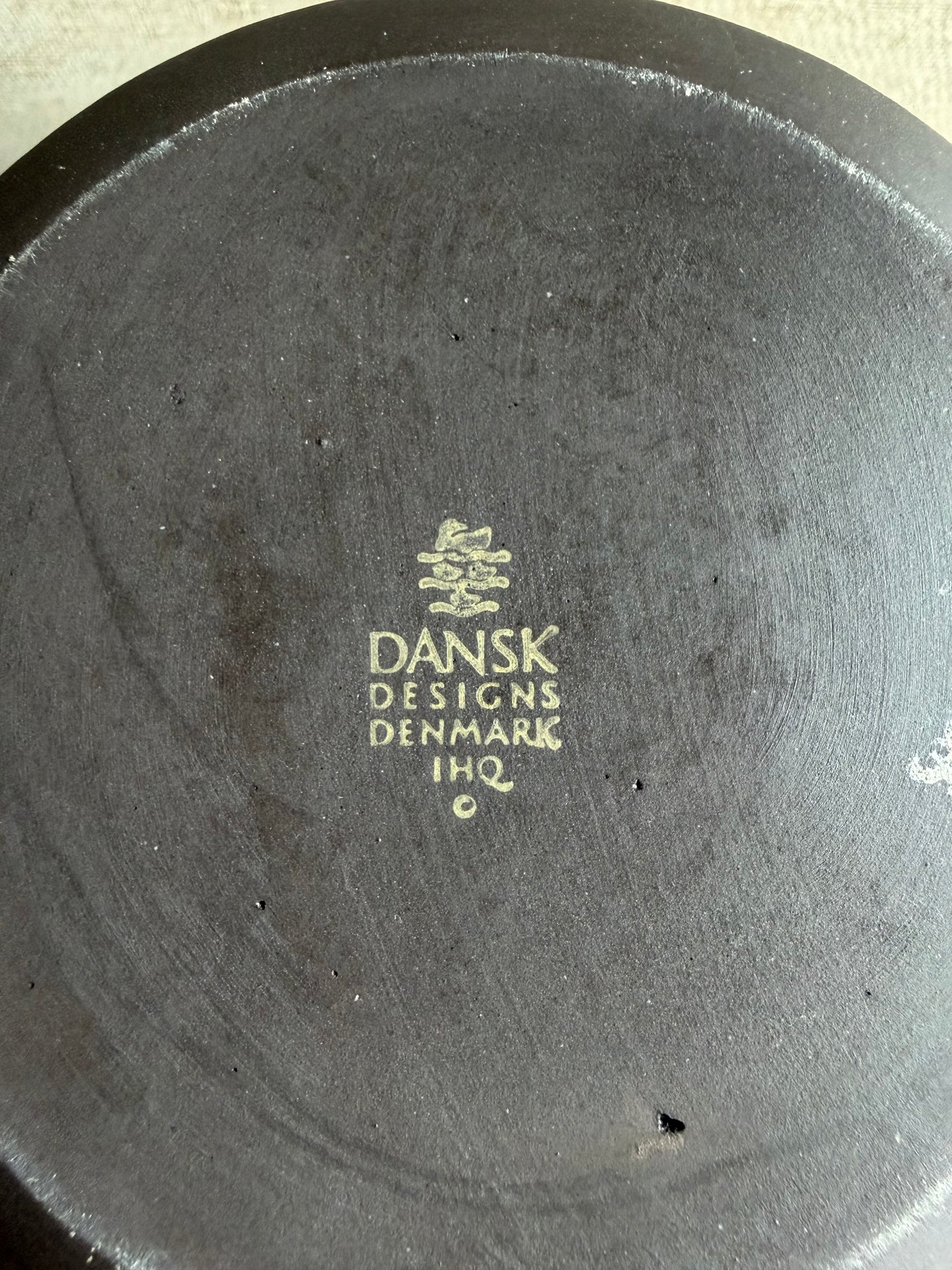 Dansk Designs Denmark logo on a dark surface