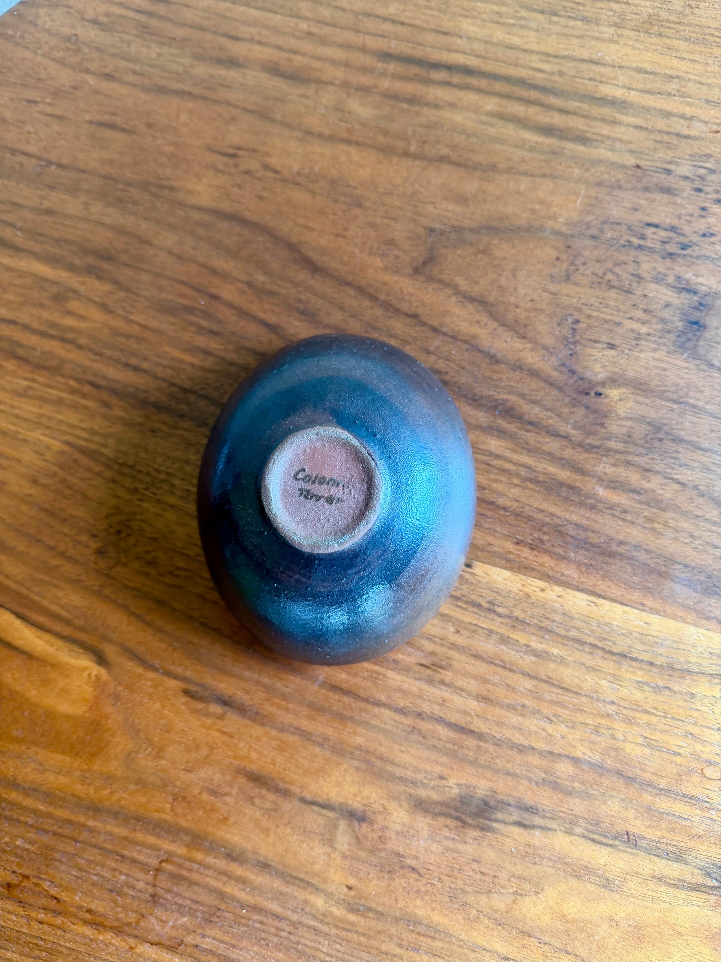 Small purple ceramic bowl on a wooden surface