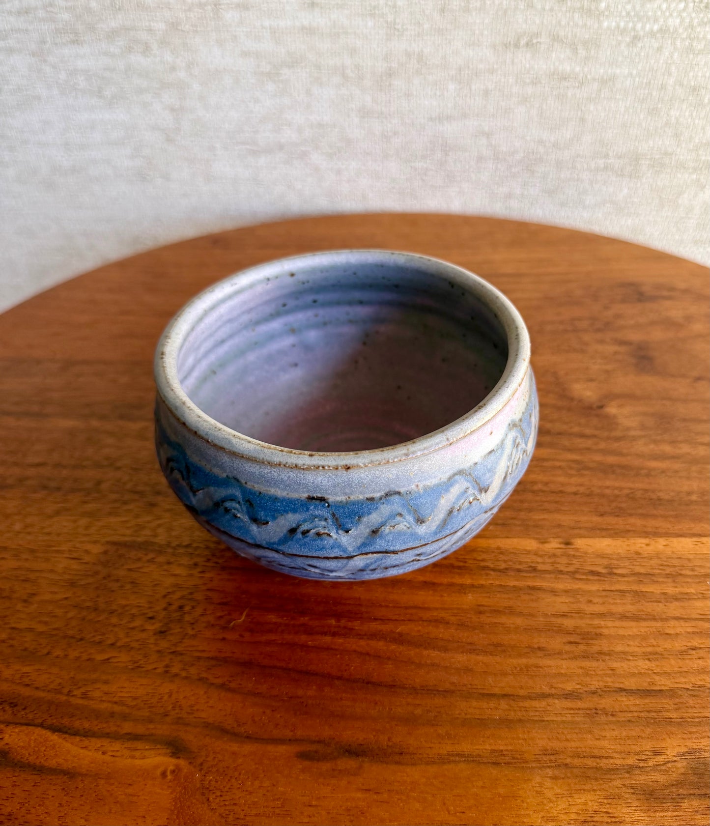Ceramic bowl with blue patterns on a wooden surface