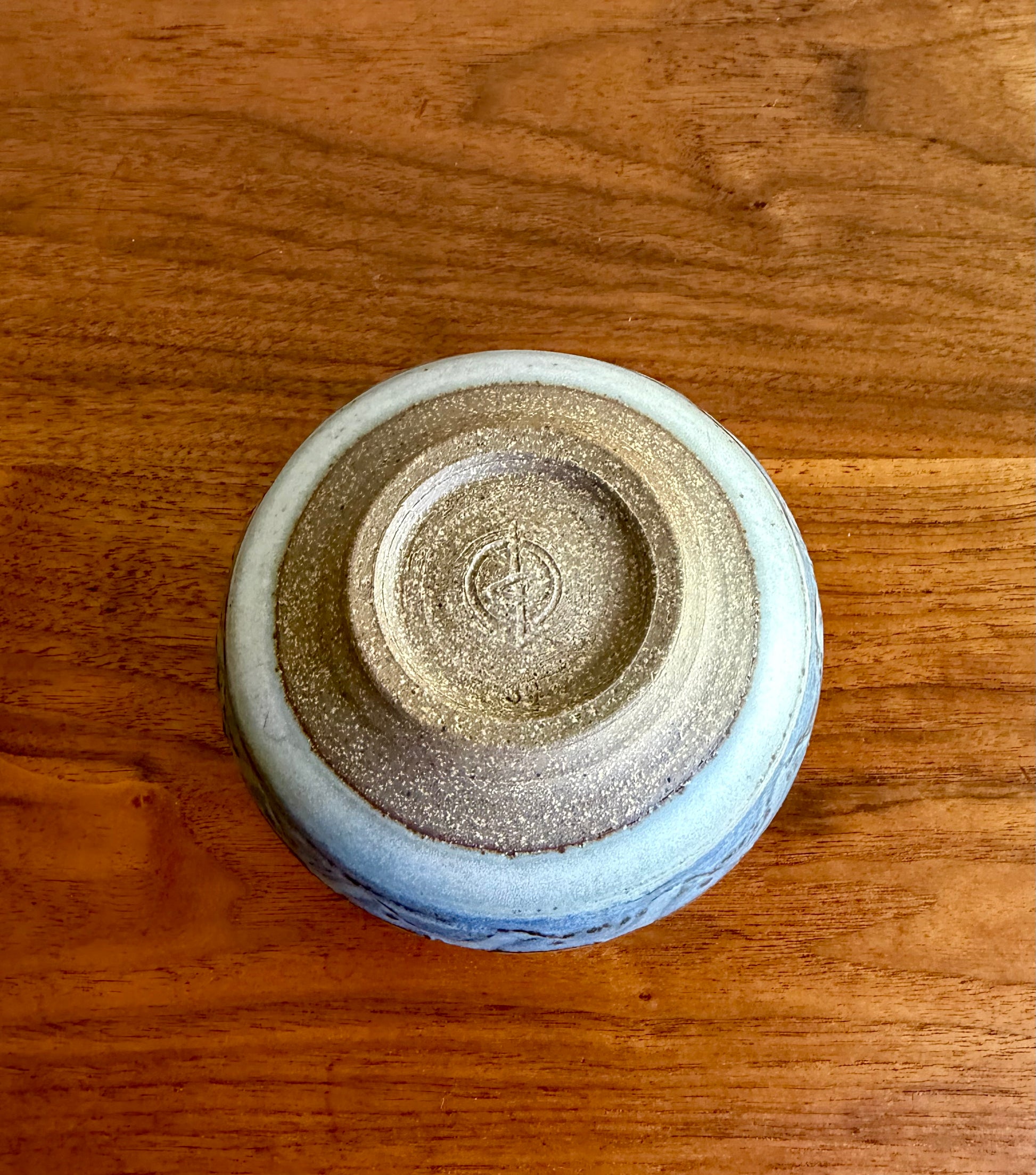 Ceramic bowl with a textured surface on a wooden table