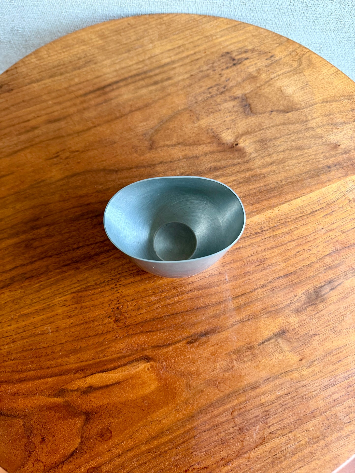 Small blue ceramic bowl on a wooden surface