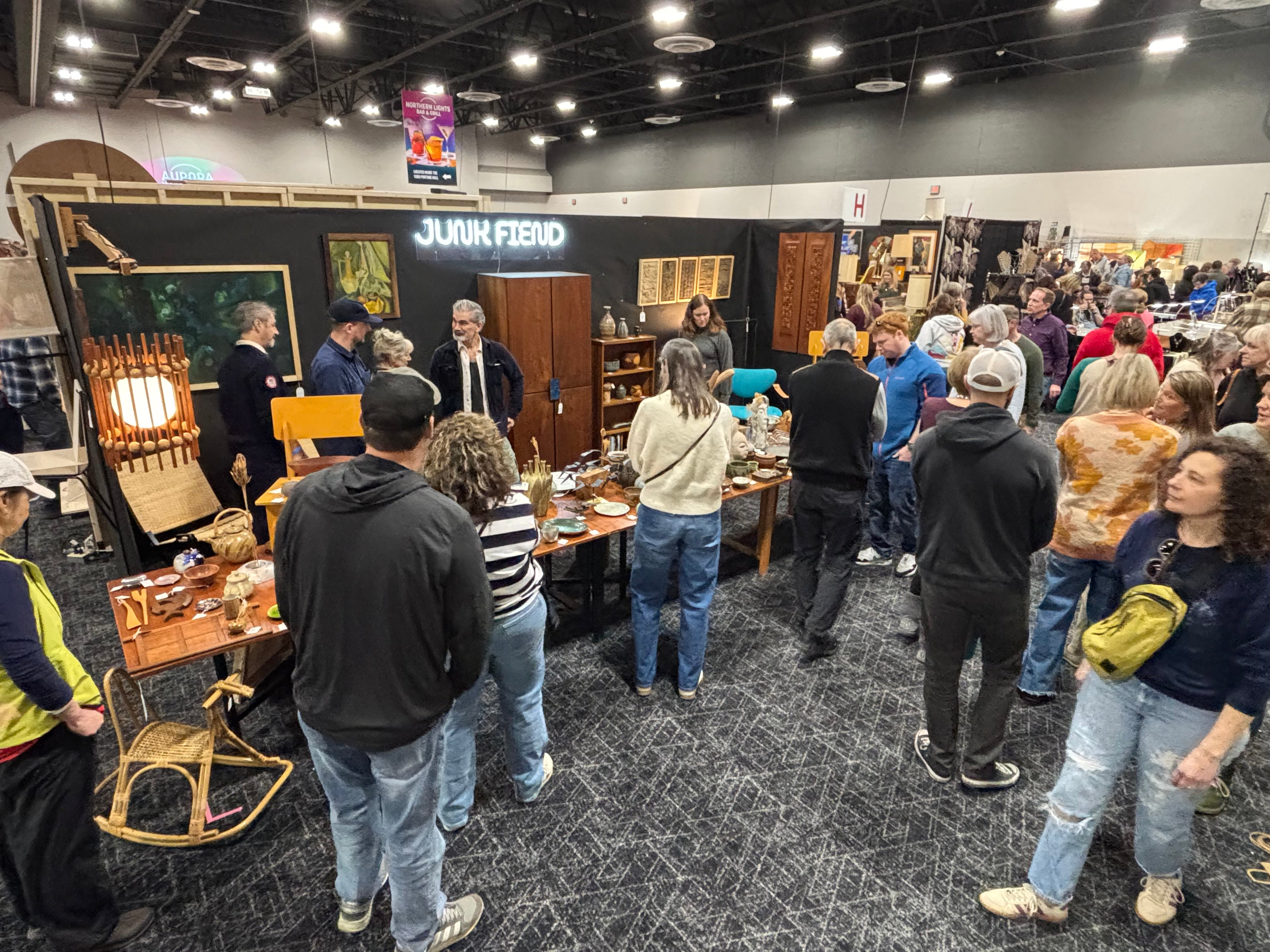 People at a trade show or convention with booths and displays.