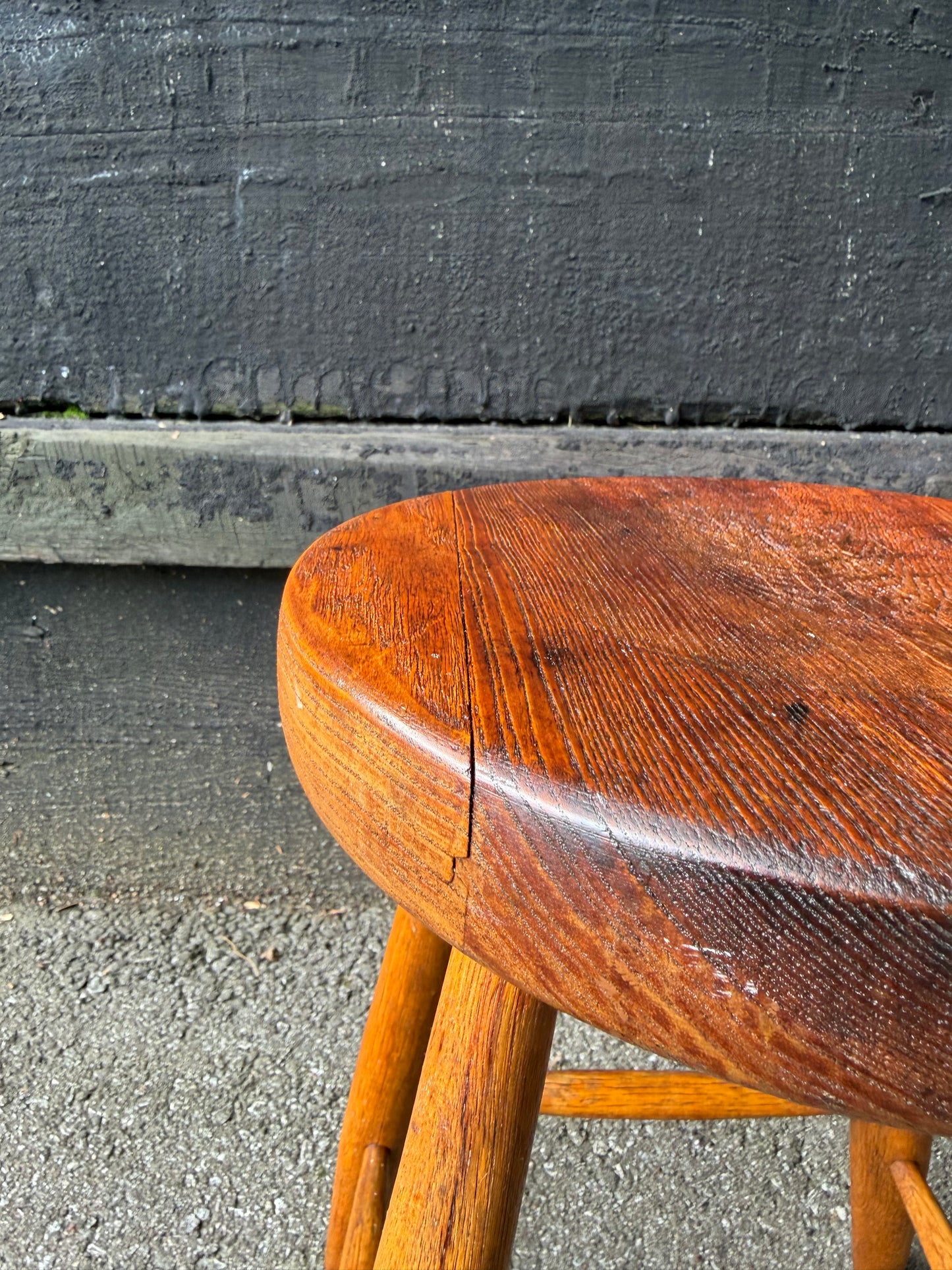 Wooden chair seat on a concrete surface