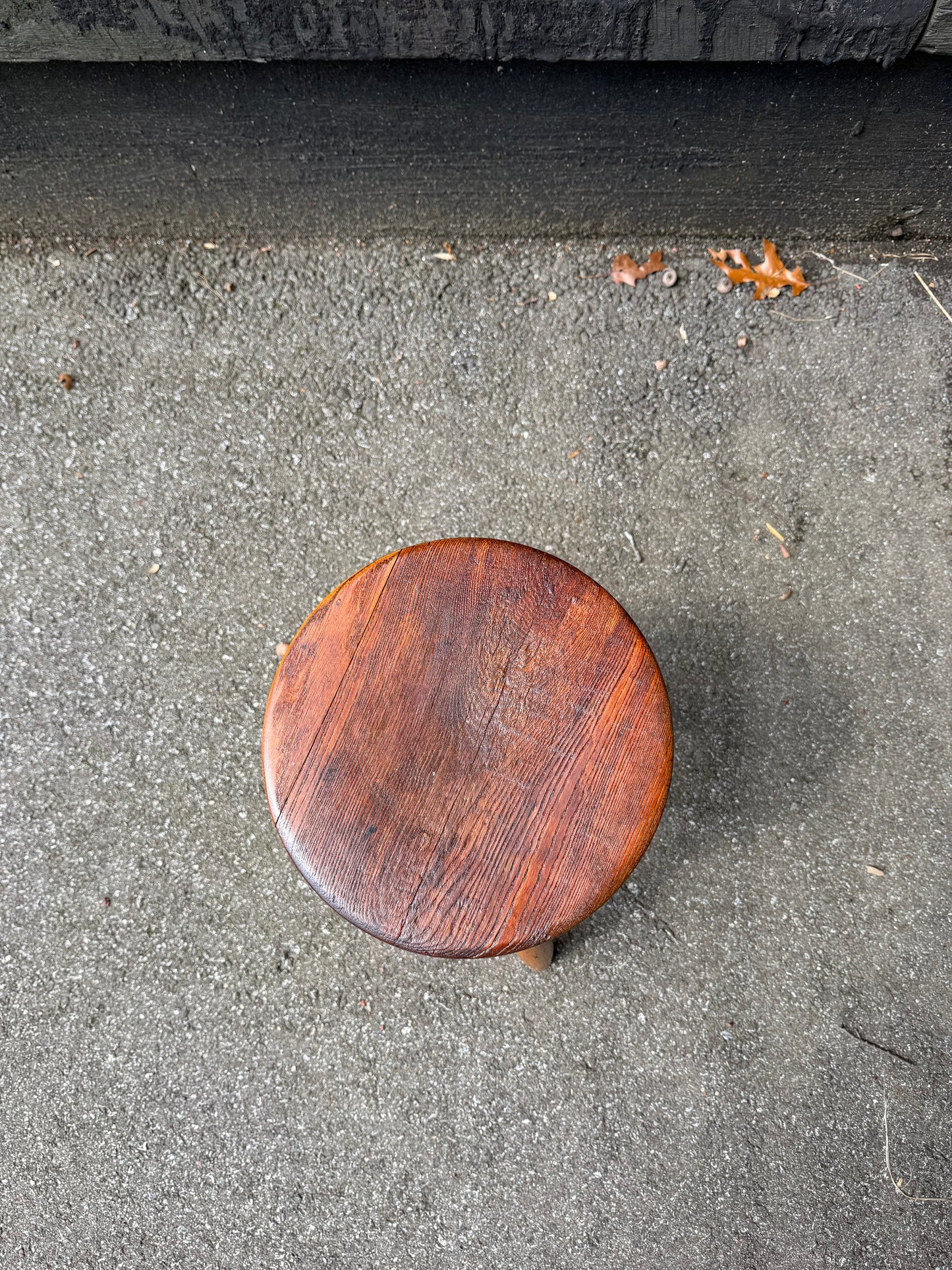 Wooden stool on a concrete floor