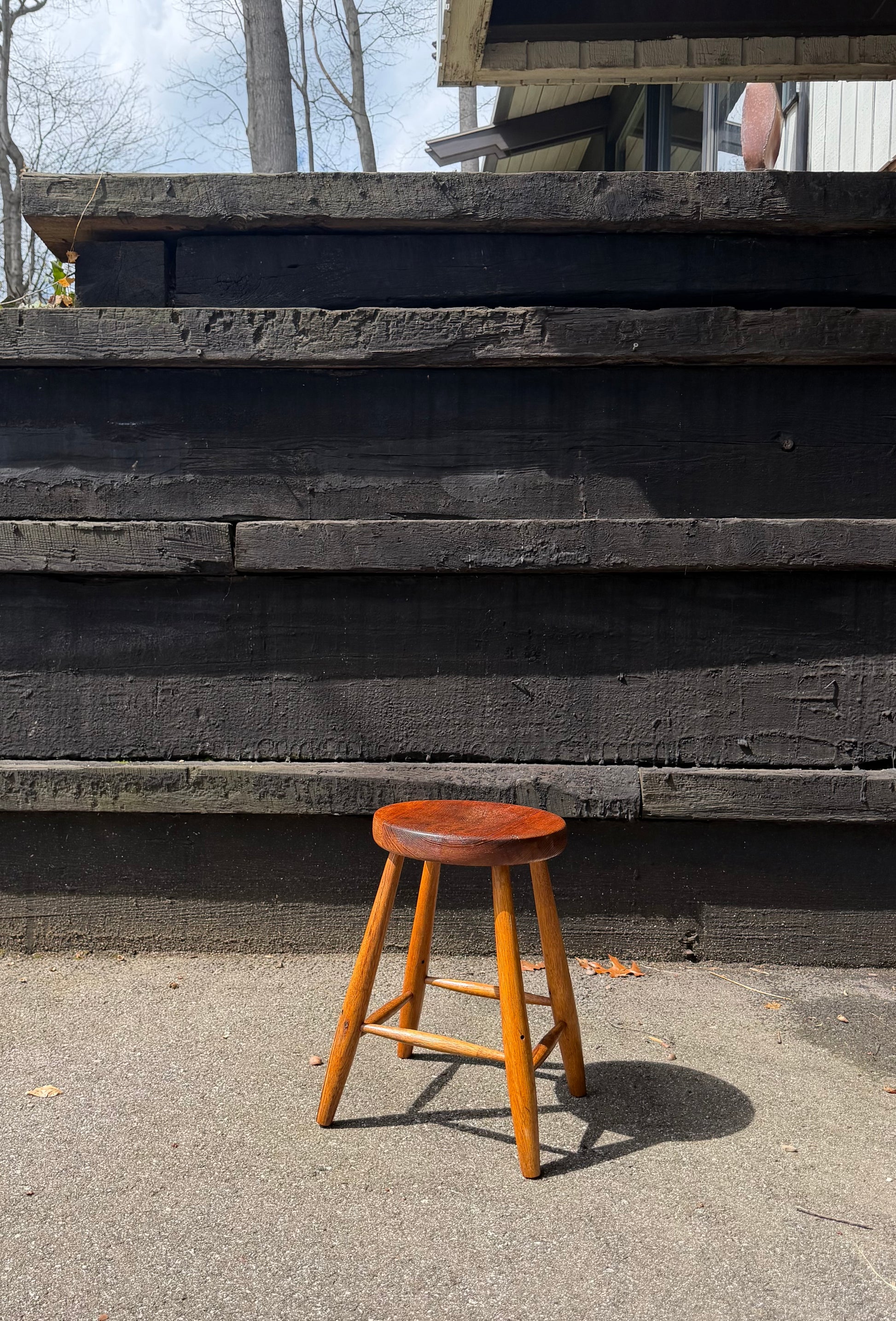 Wooden stool in front of a wooden wall with steps