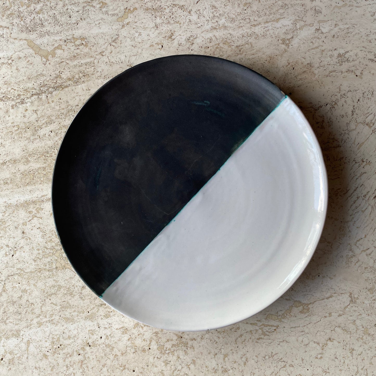 Black and white ceramic dish on a beige surface