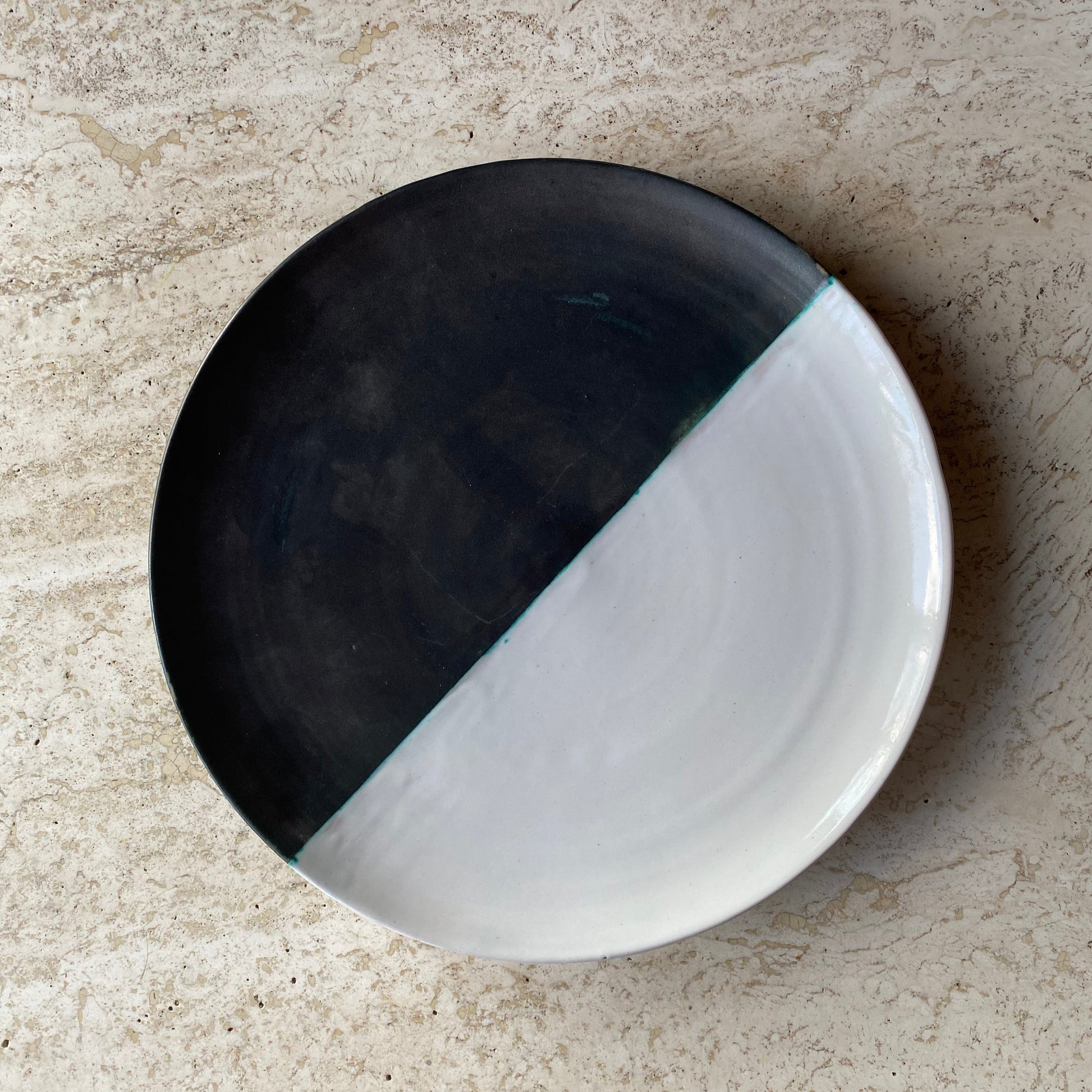 Black and white ceramic dish on a beige surface