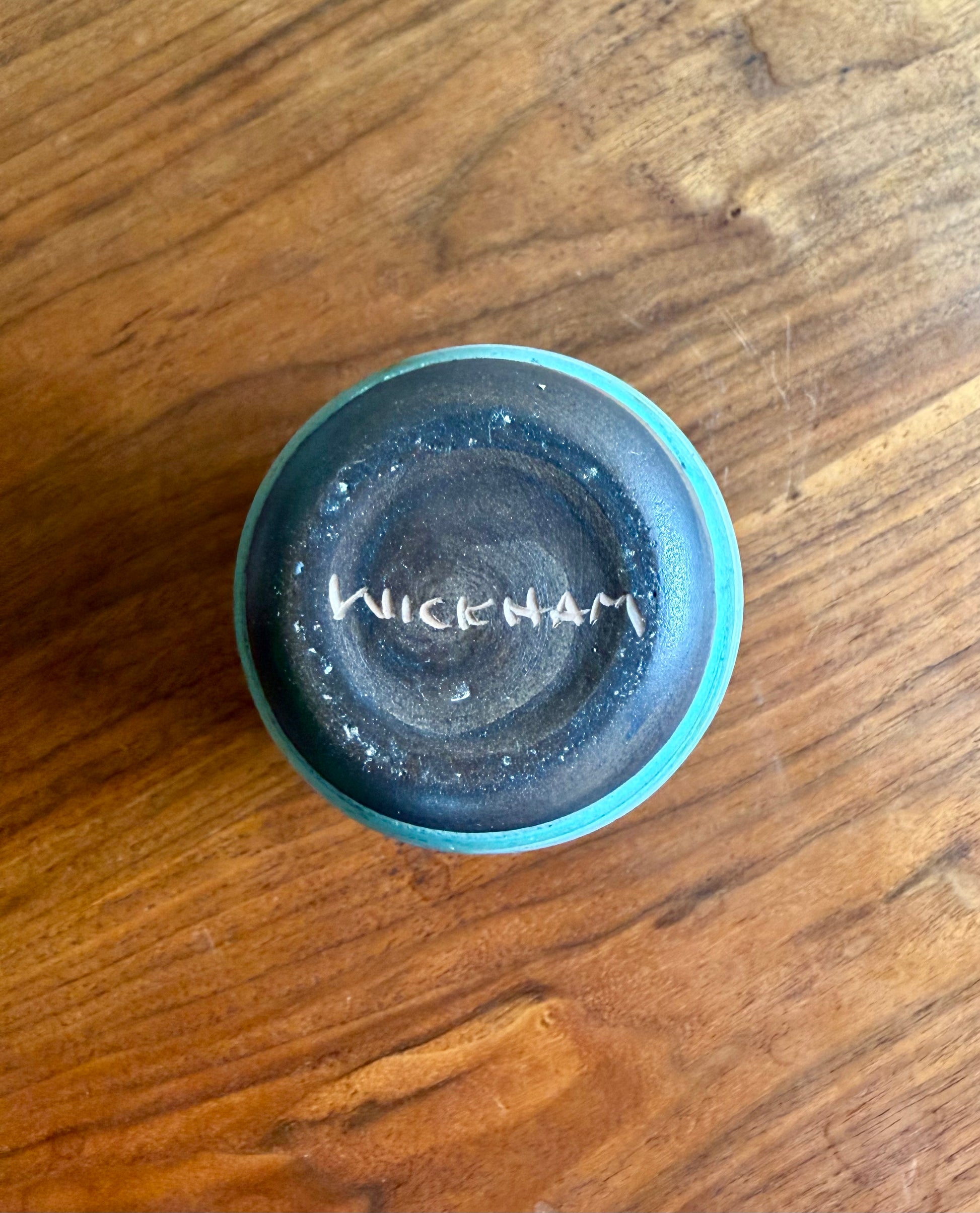 Blue ceramic dish with 'Wickham' branding on a wooden surface
