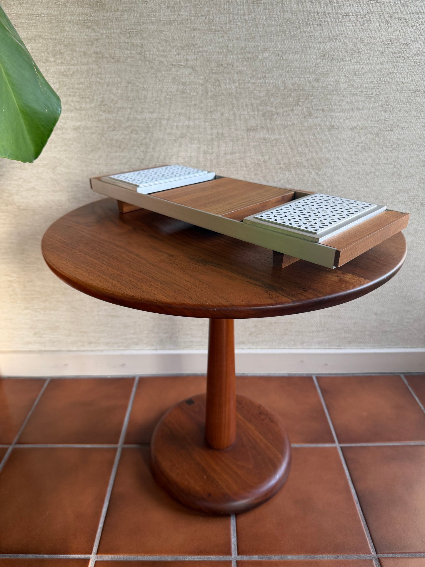 Wooden serving tray with a textured surface and tiled wall background