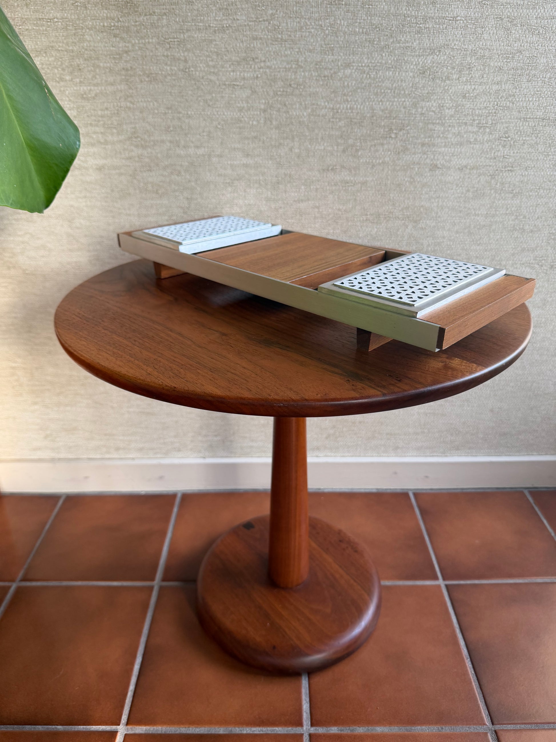 Wooden serving tray with a textured surface and tiled wall background