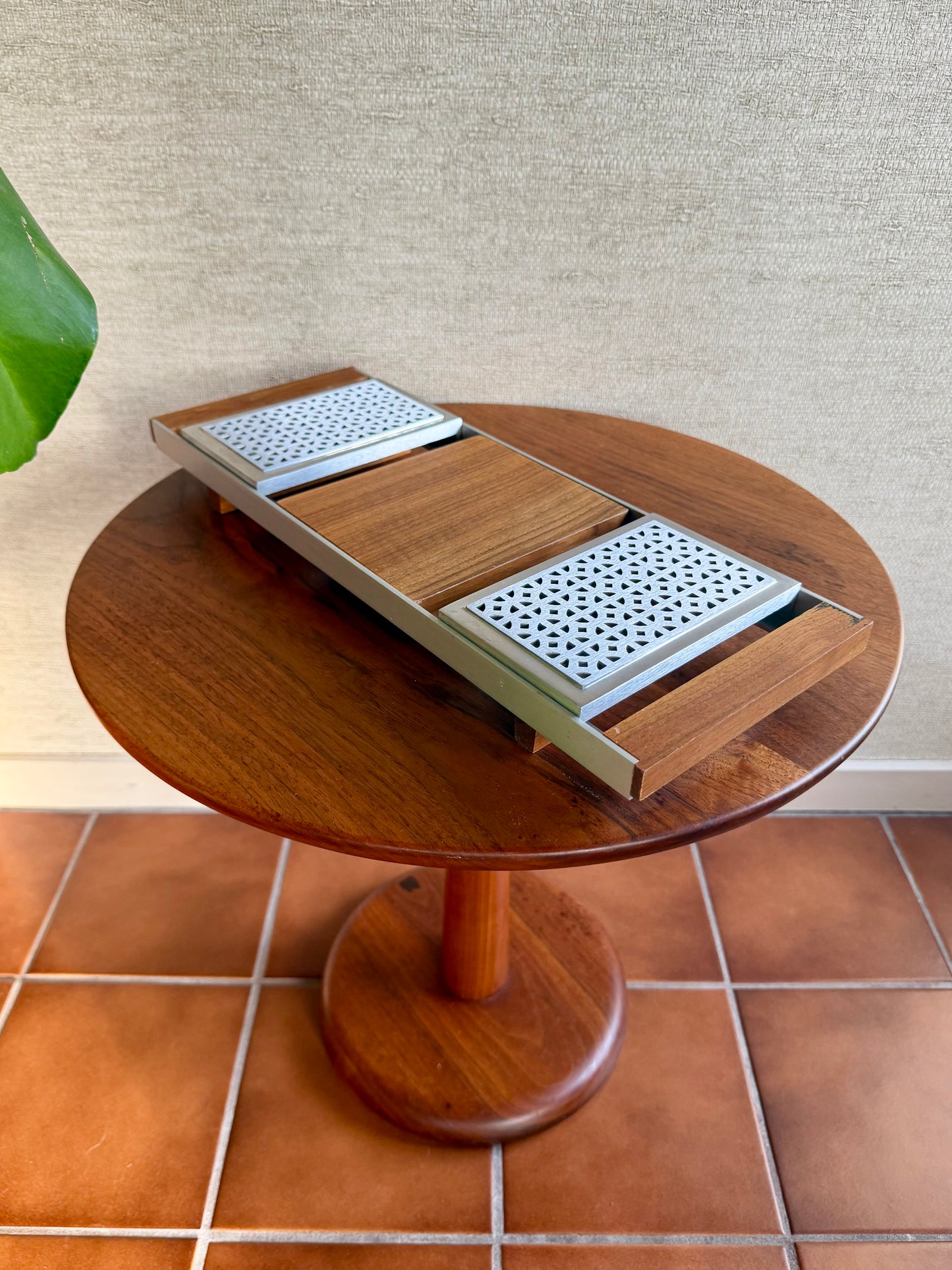 Wooden table with a geometric design on a tiled floor