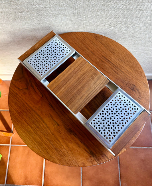 Wooden table with metal grates on a tiled floor