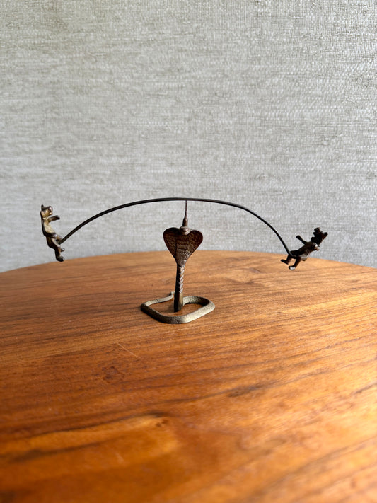 Decorative metal sculpture with a heart on a wooden surface