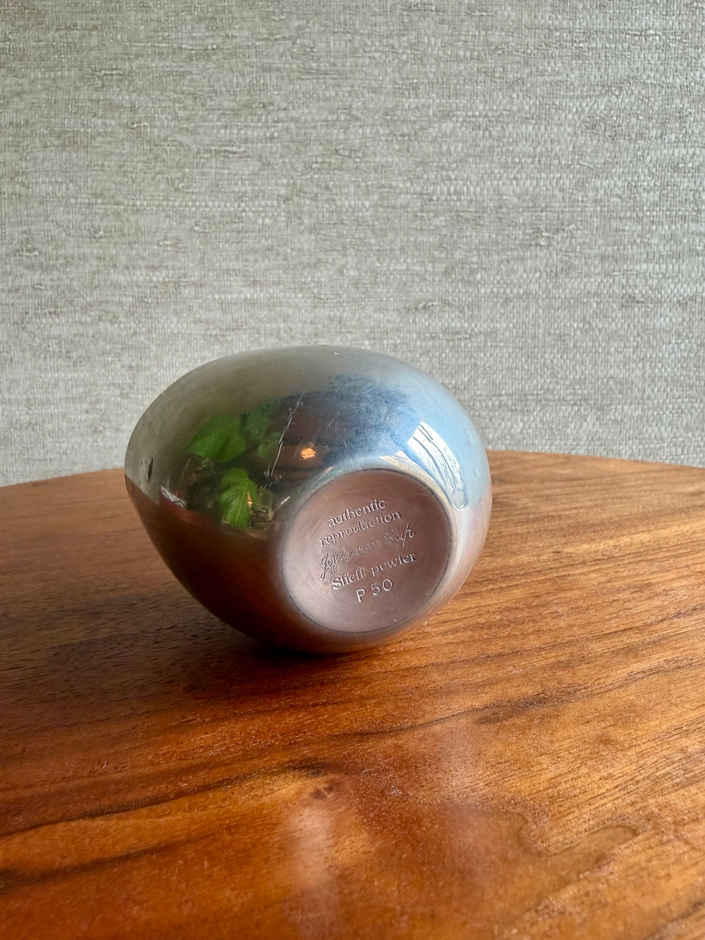 Small metal bowl with a textured surface on a wooden surface