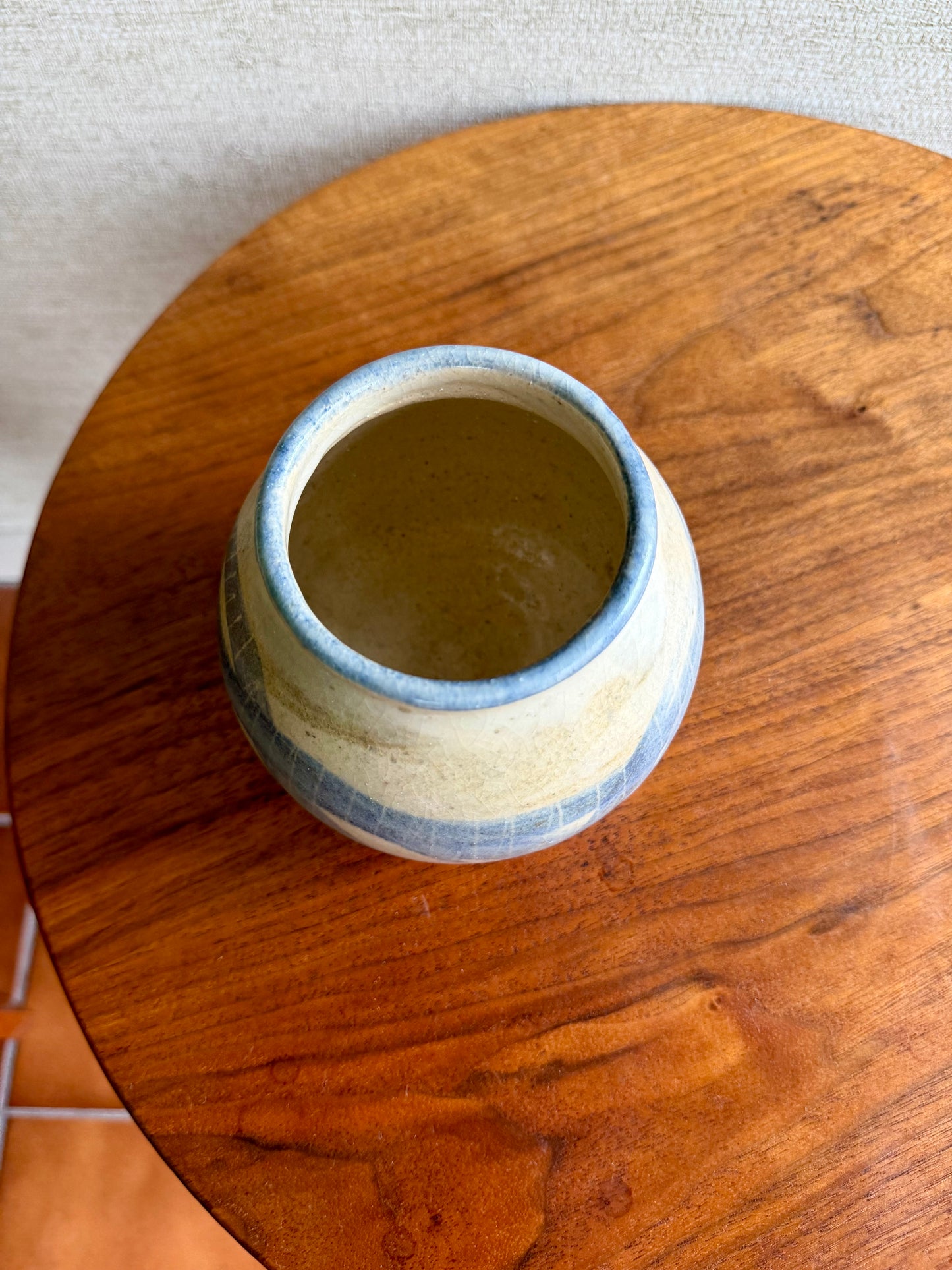 Small ceramic pot on a wooden surface