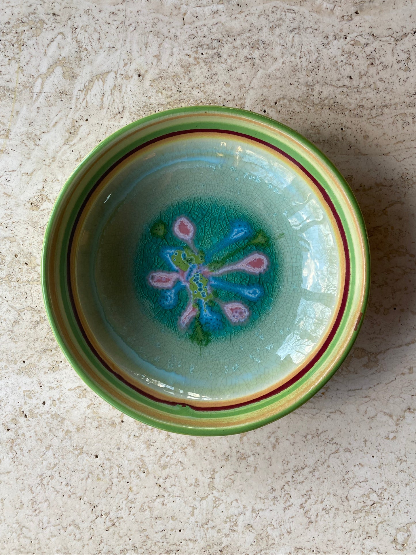 Ceramic bowl with floral design on a textured surface