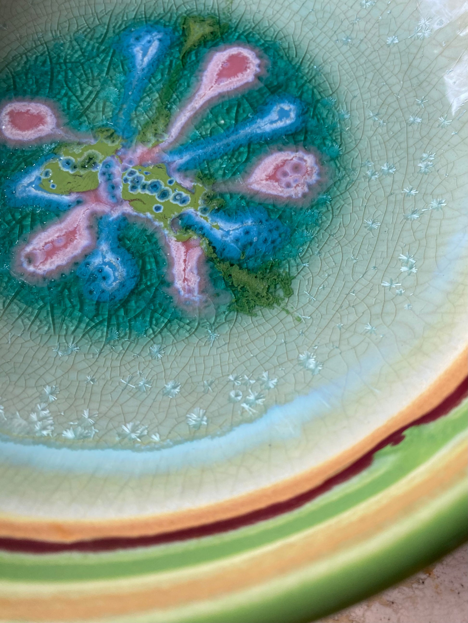 Close-up of a ceramic plate with a decorative design on a textured surface