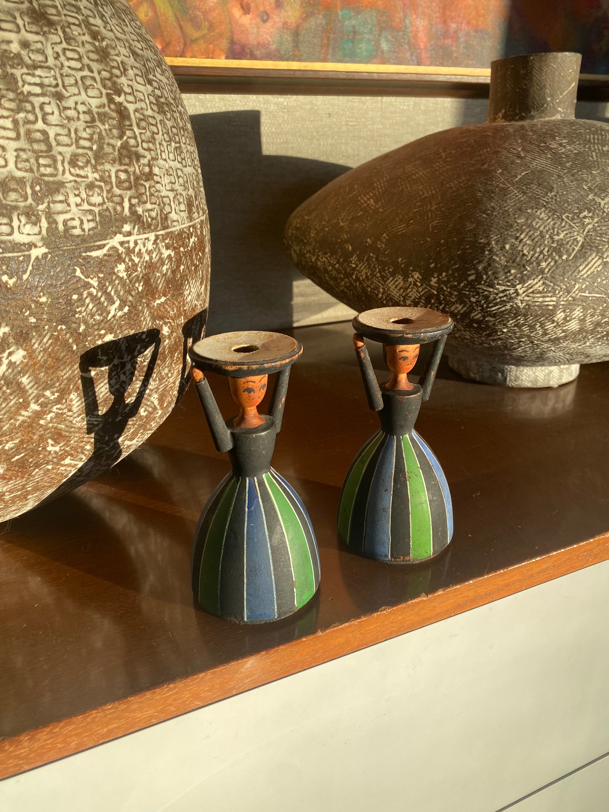 Decorative items on a wooden shelf with a textured surface