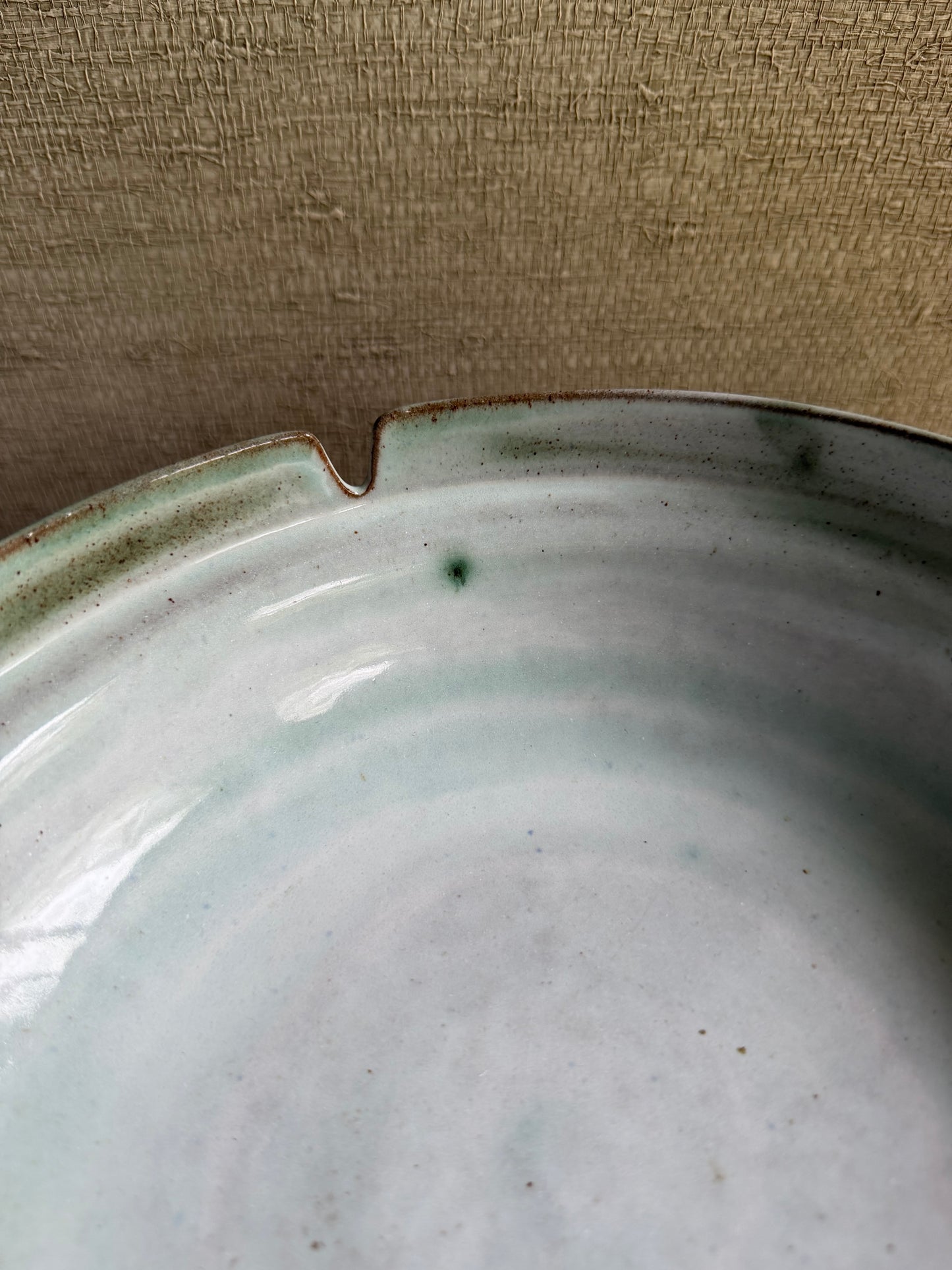 Close-up of a ceramic plate with a textured background