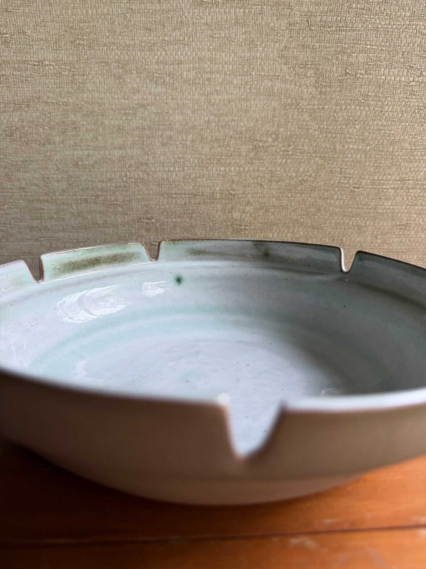 Ceramic bowl with a textured beige background