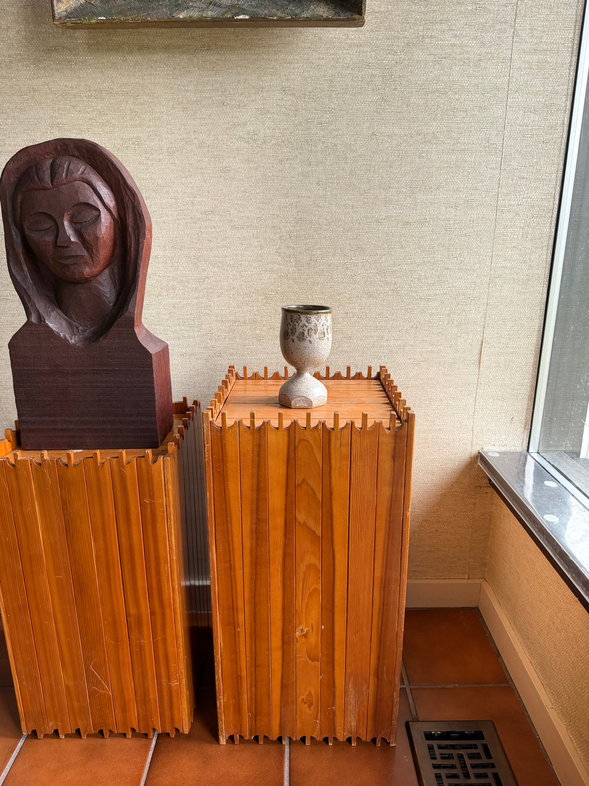 Wooden chest with a decorative handle on a textured wall background