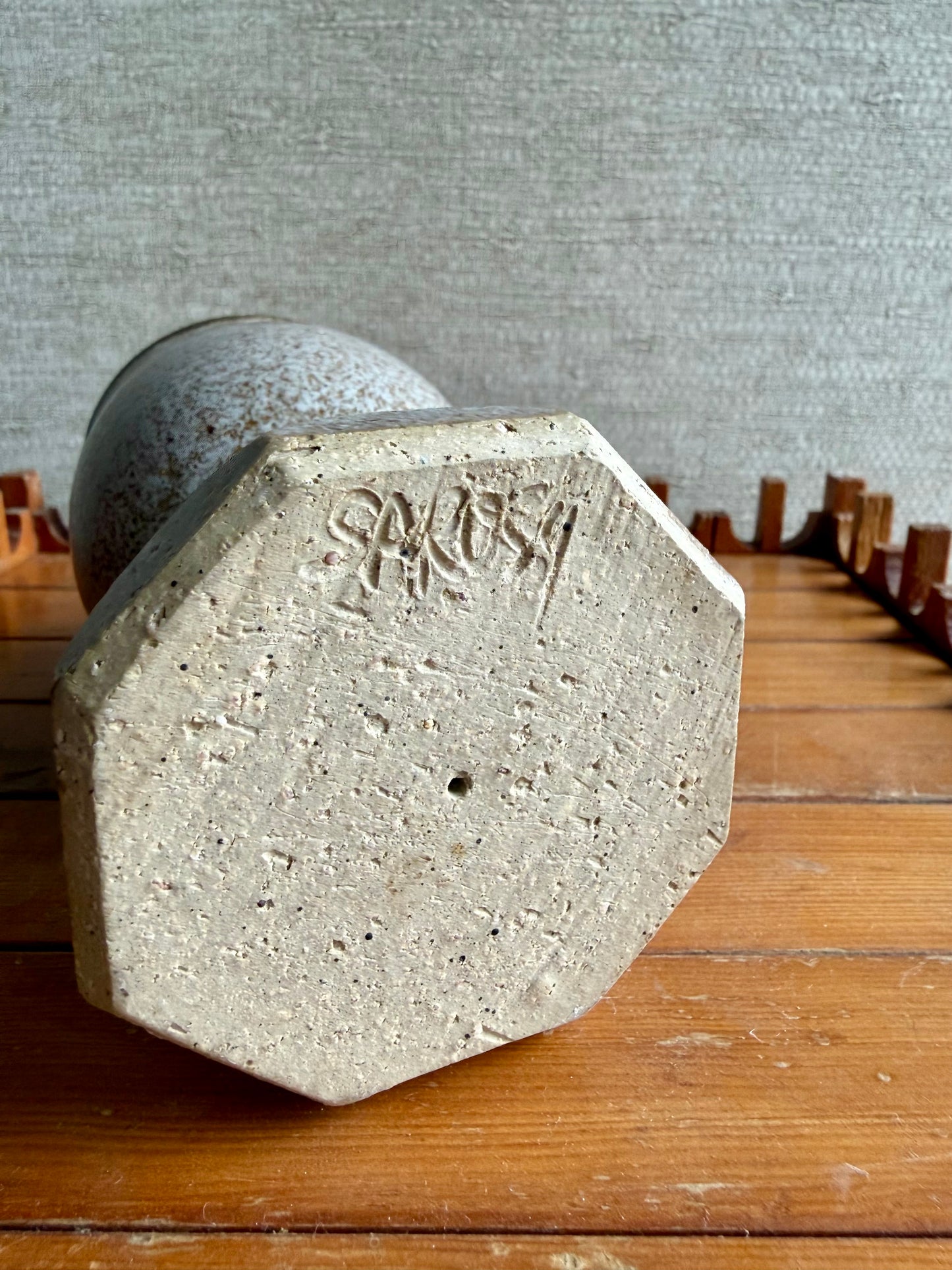 Concrete weight with 'SMOK' branding on a wooden surface