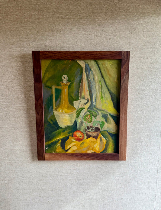 Framed still life painting on a textured wall