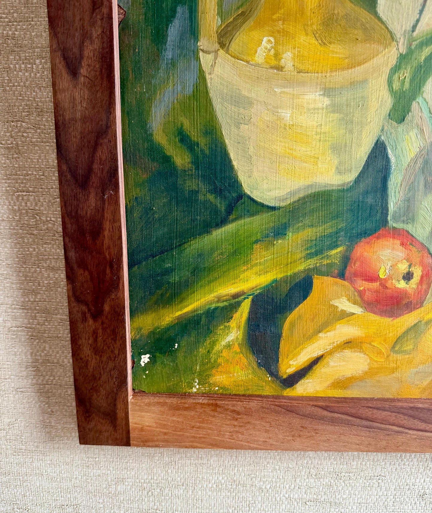 Close-up of a painting with a teapot and apples on a textured surface