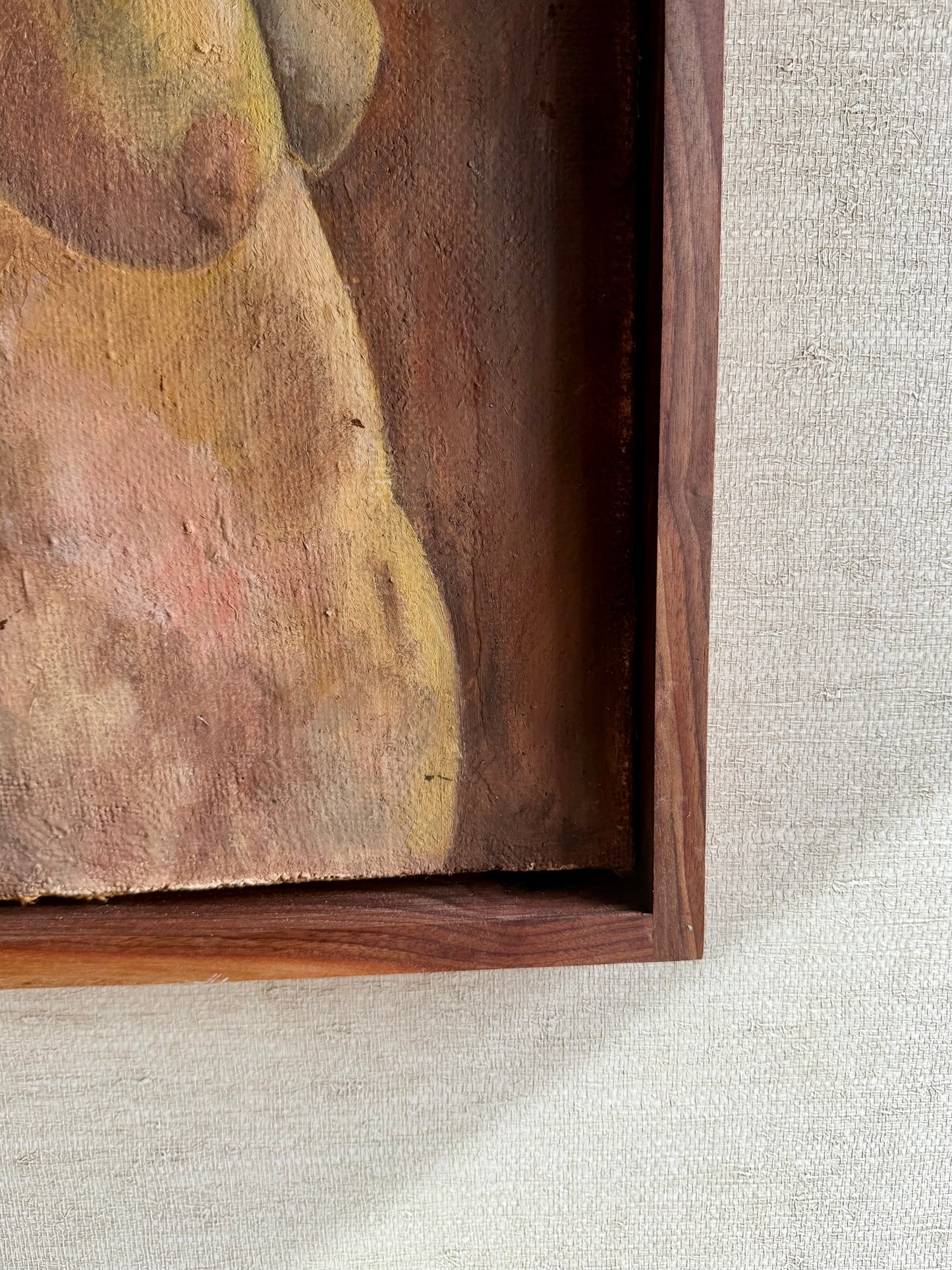 Close-up of a wooden frame with an abstract painting on a textured gray surface