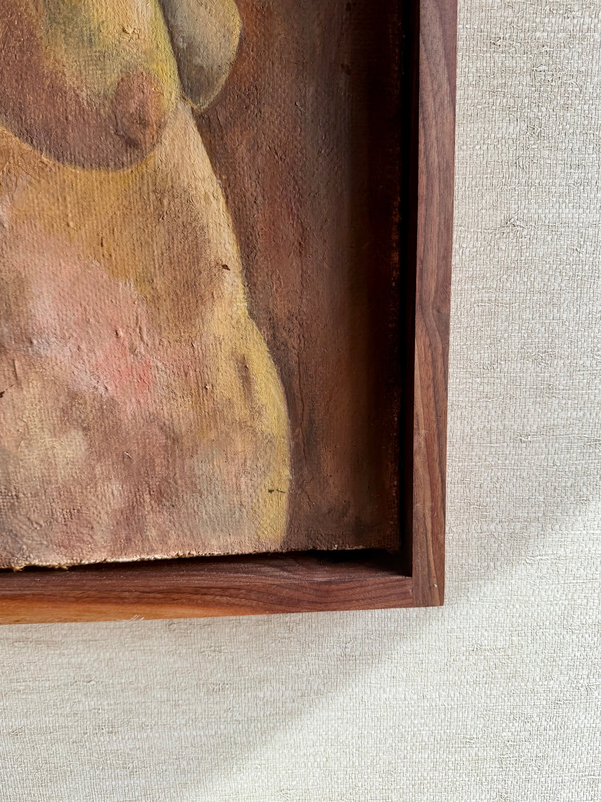 Close-up of a wooden frame with an abstract painting on a textured gray surface