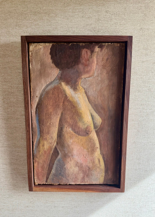 Framed painting of a nude figure on a textured wall.