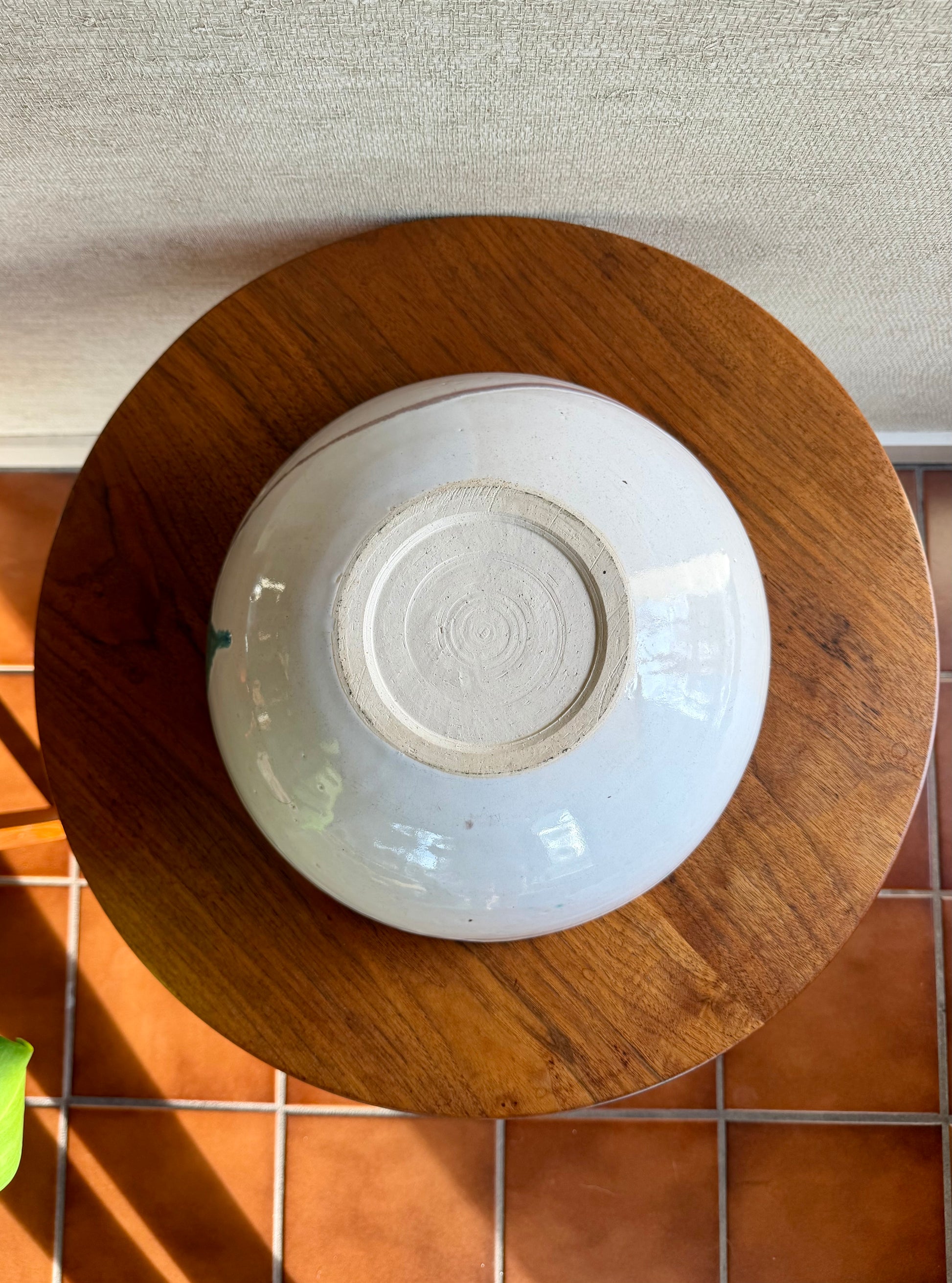 White ceramic bowl on a wooden surface with a textured background