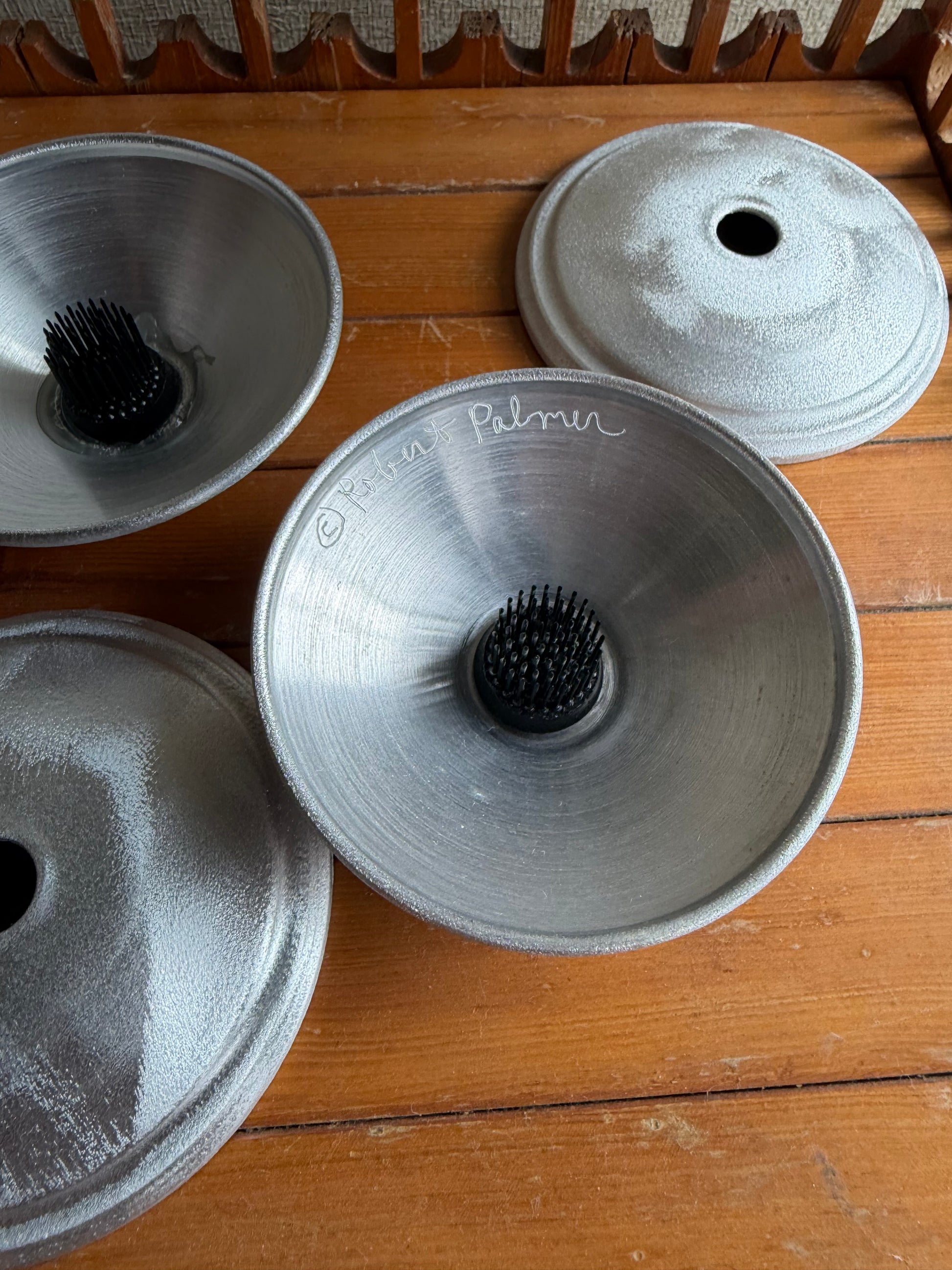 Metal coffee filters on a wooden surface