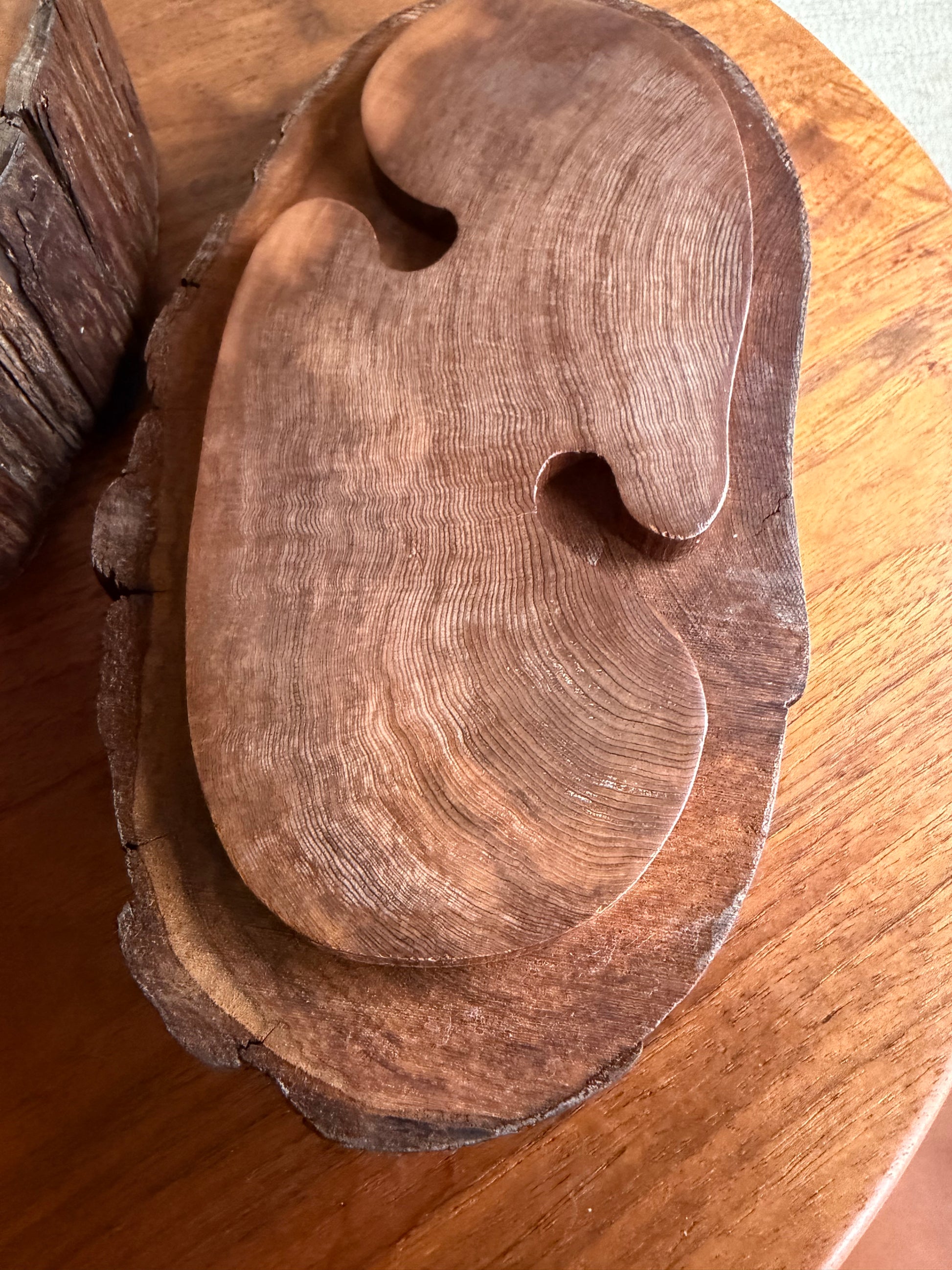 Wooden carving of a box lid on a wooden surface
