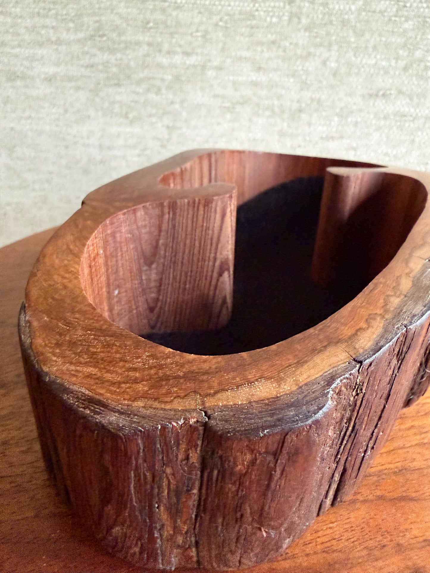 Wooden log with a natural, rustic finish on a light background