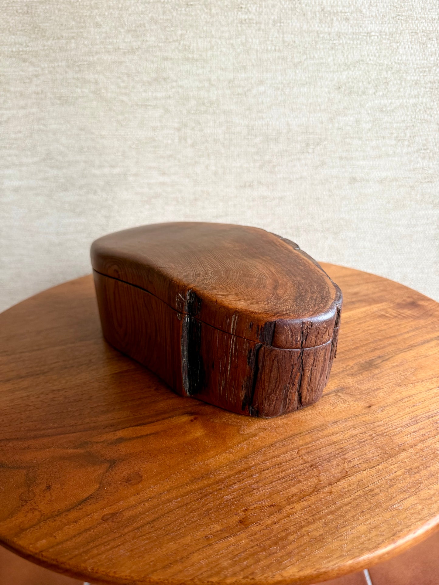 Wooden box with a textured surface on a wooden table