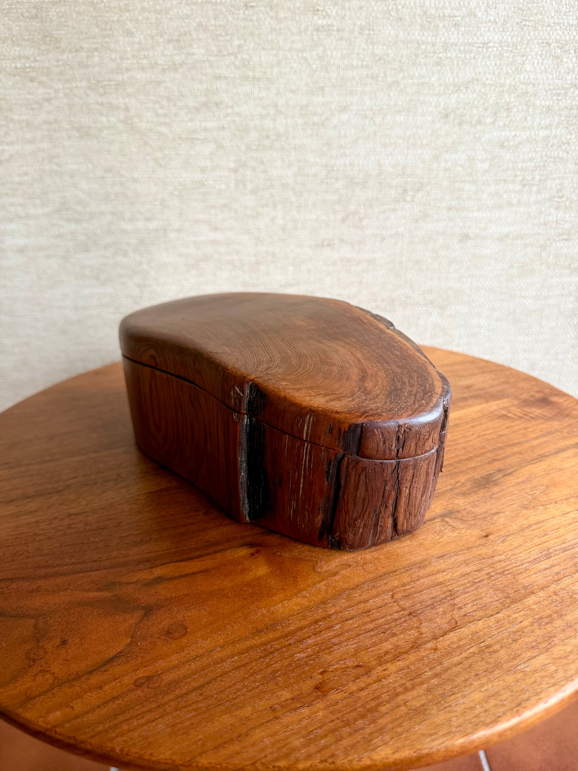 Wooden box with a textured surface on a wooden table