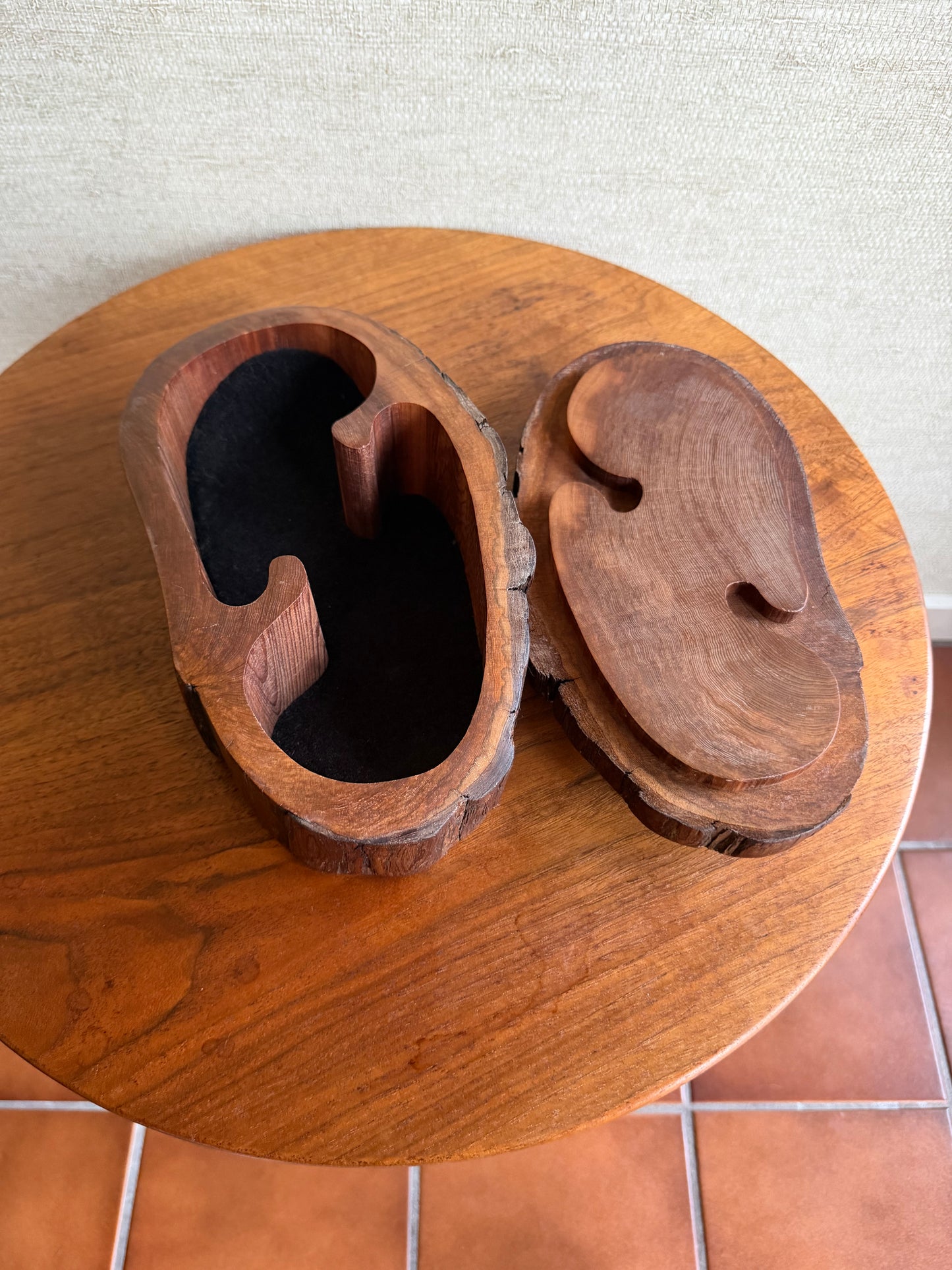 Wooden sculpture with abstract design on a textured wall