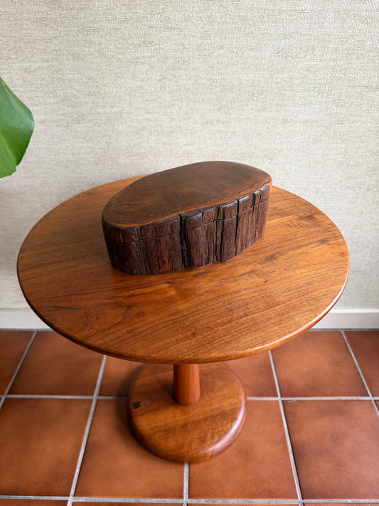 Wooden shower head mounted on a tiled wall