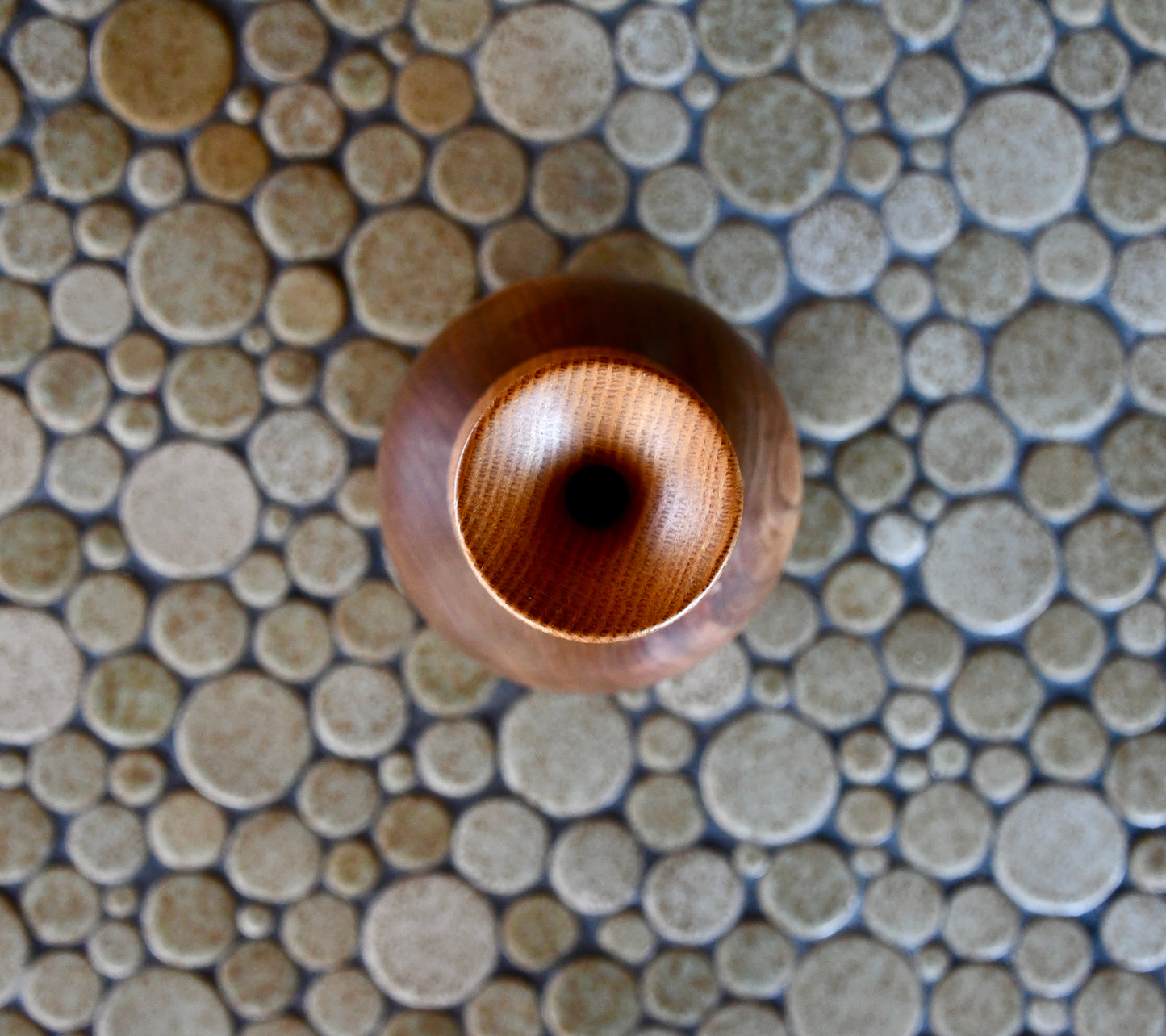 Wooden bead on a mosaic tile background