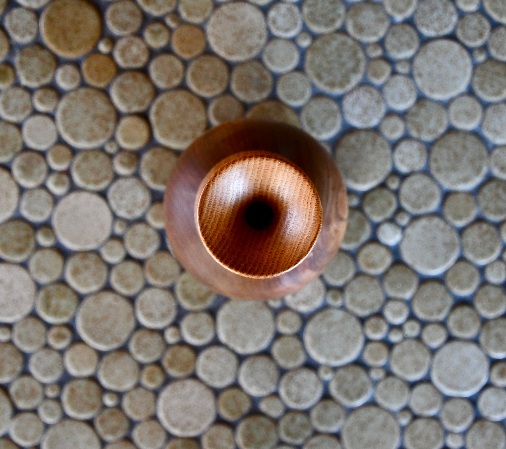 Wooden bead on a mosaic tile background