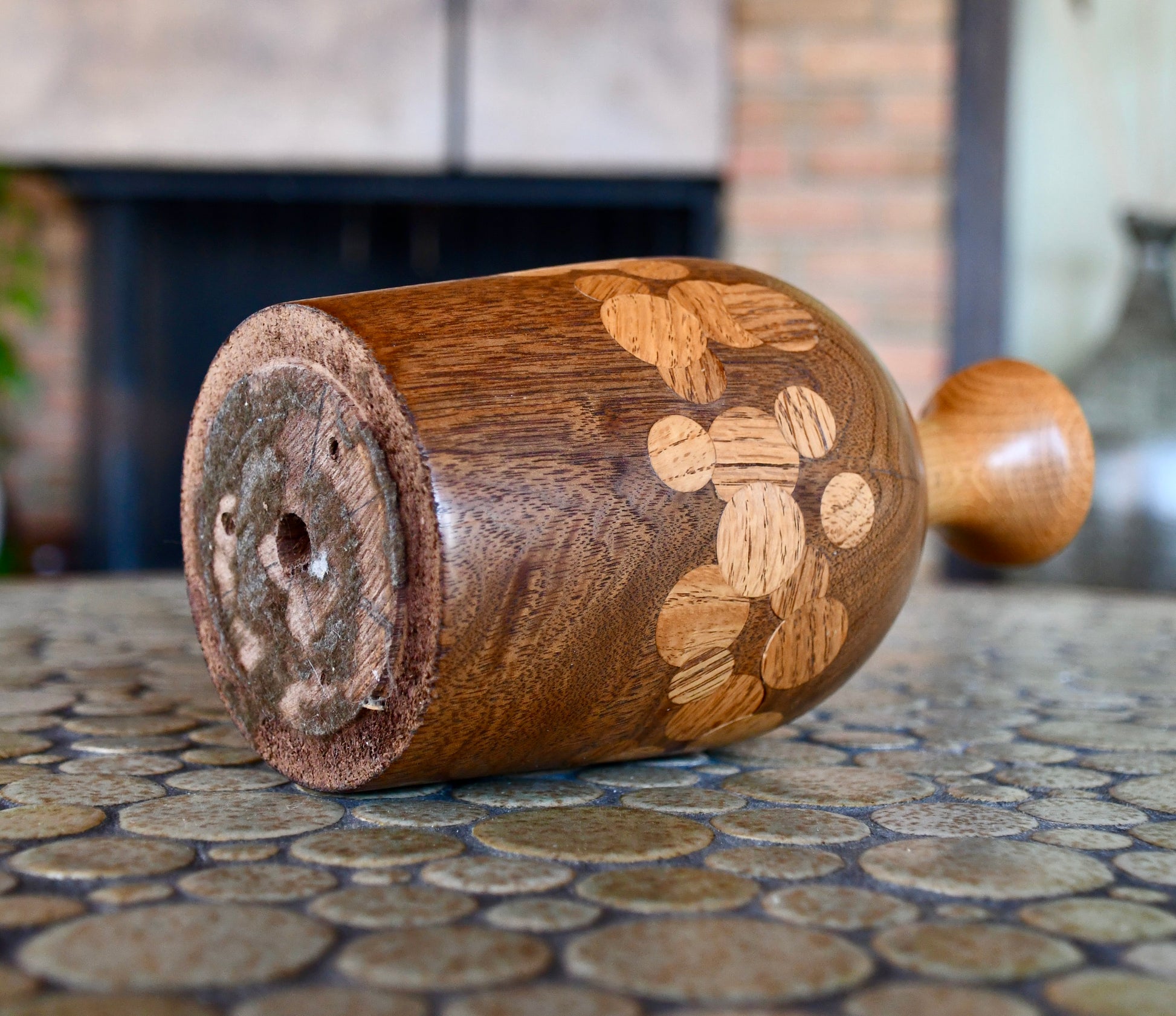 Wooden Vase with floral patterns on a tiled surface