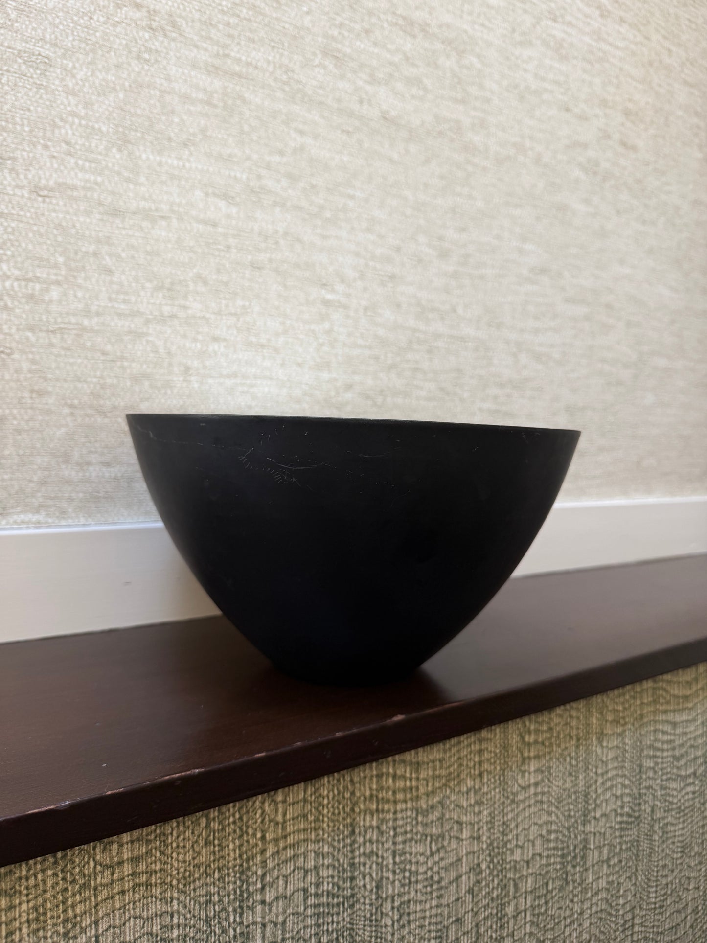 Black triangular object on a textured surface