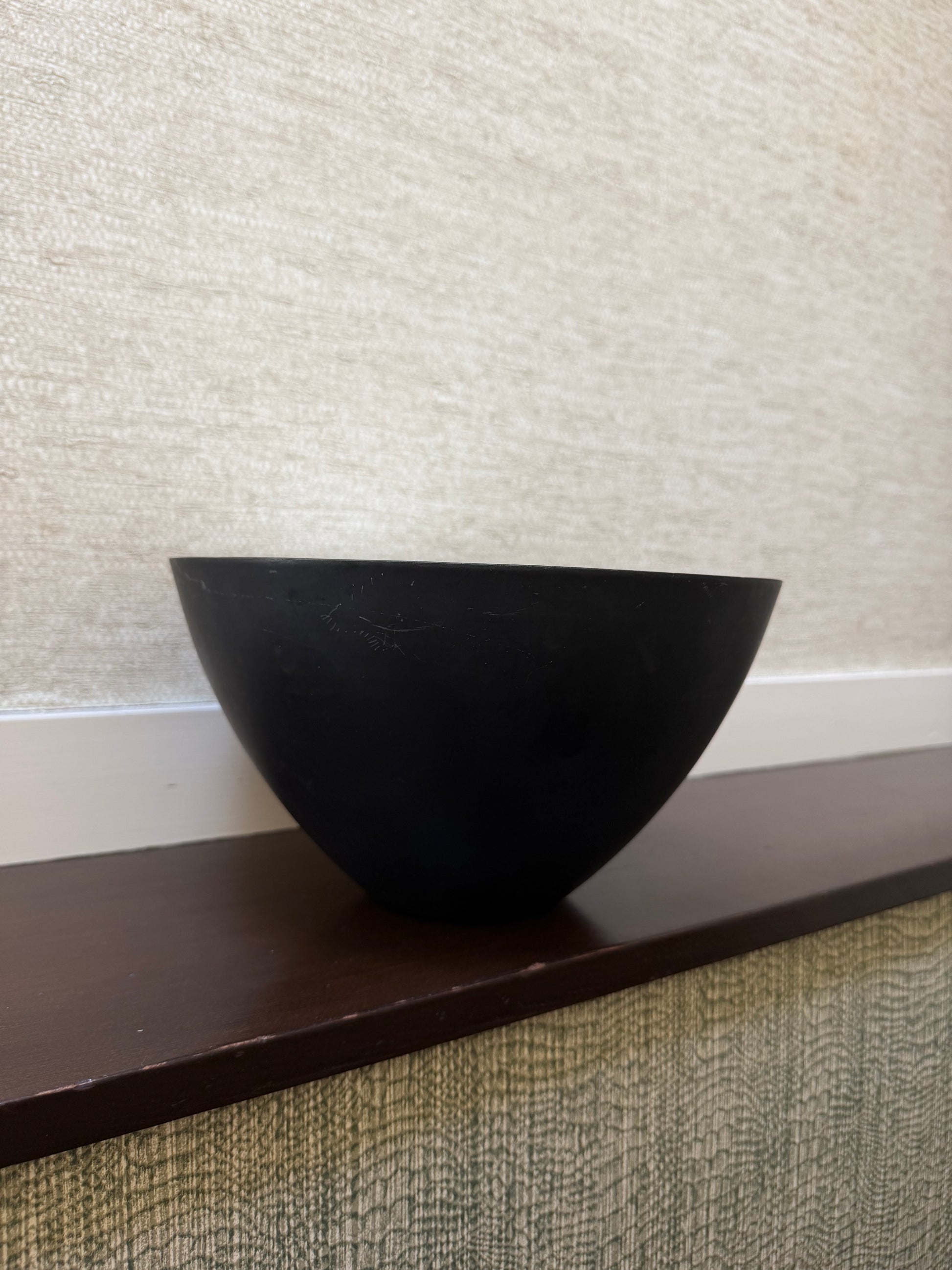 Black triangular object on a textured surface