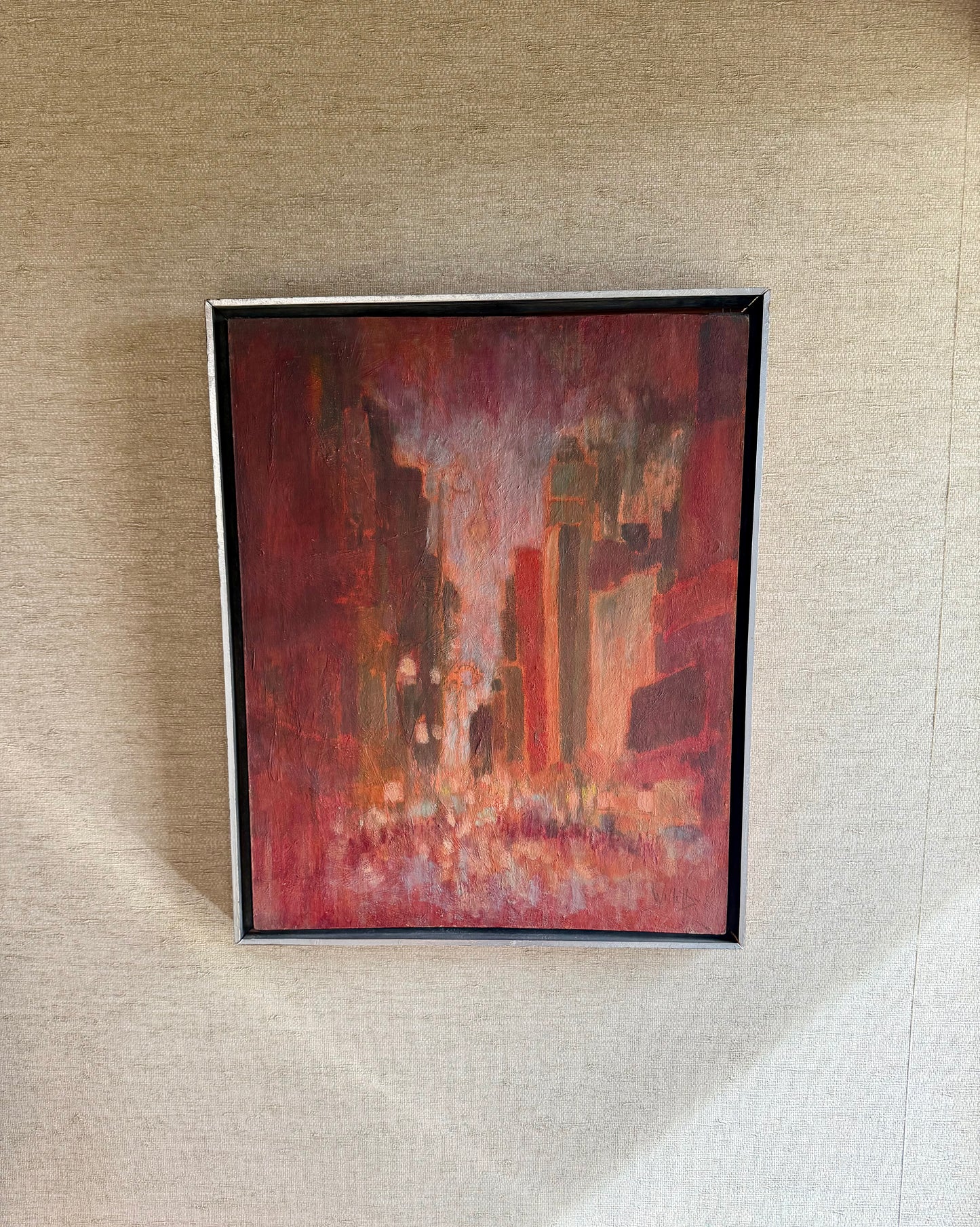 Framed abstract painting on a textured wall