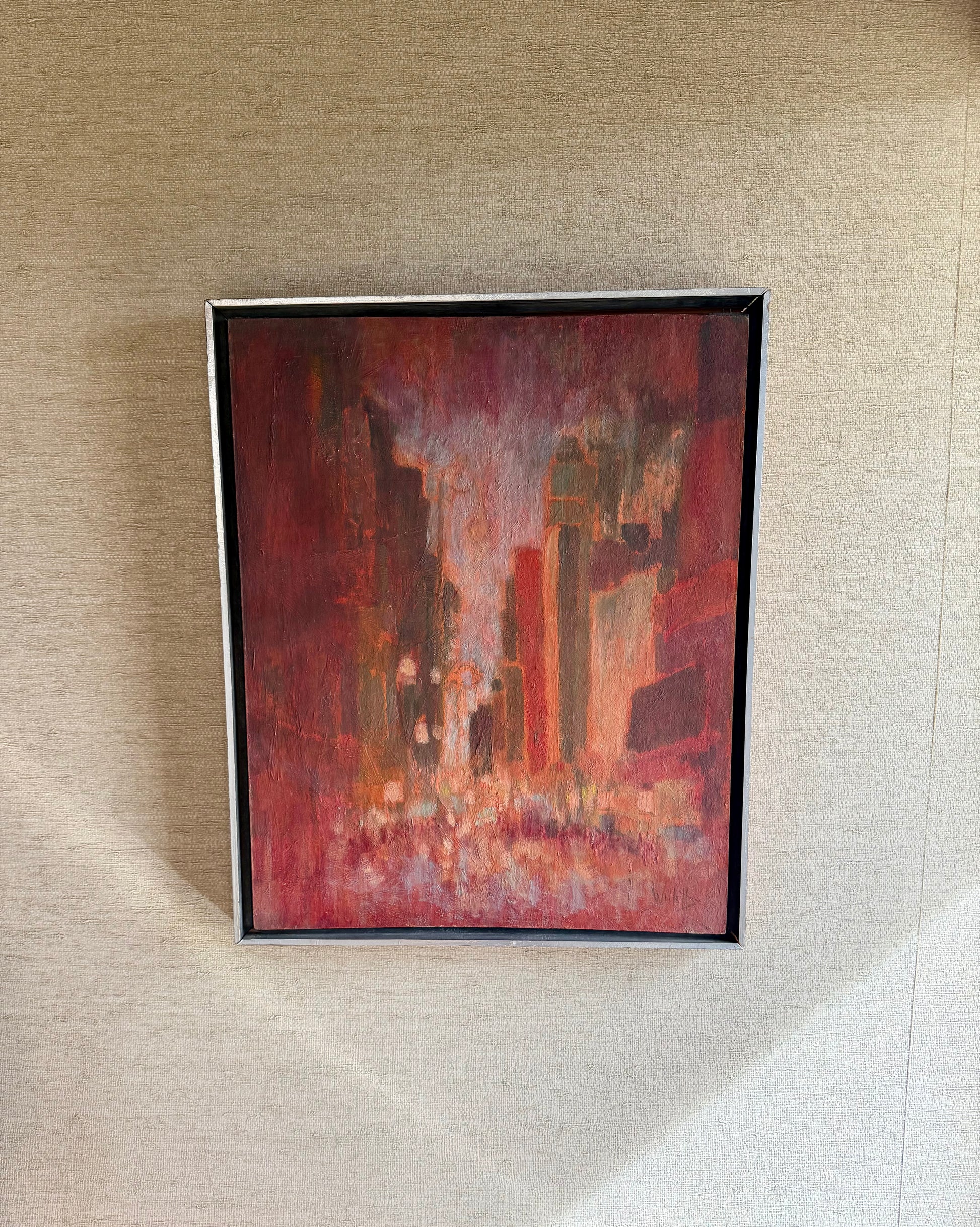 Framed abstract painting on a textured wall