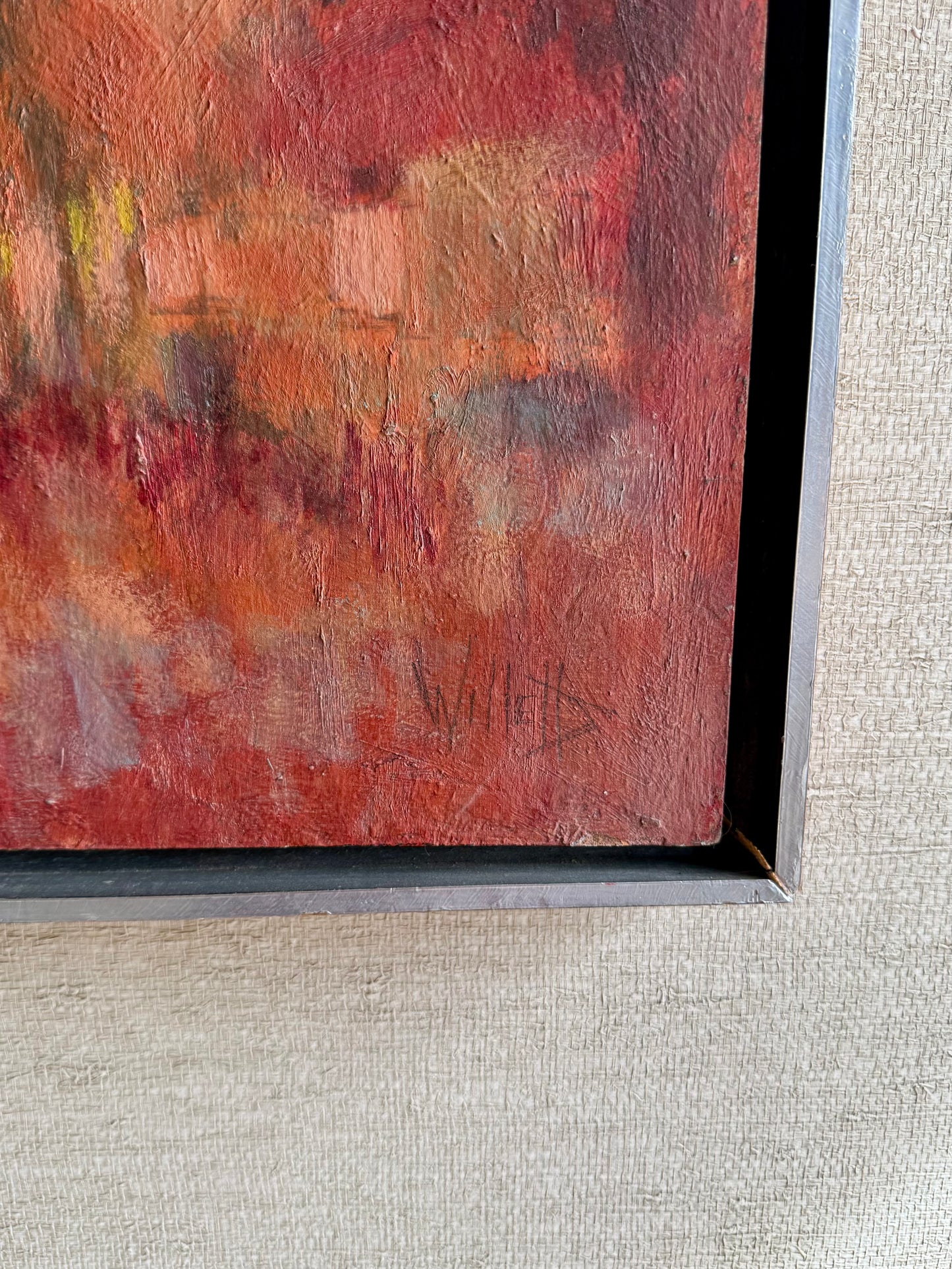 Abstract painting with a signature on a textured gray background