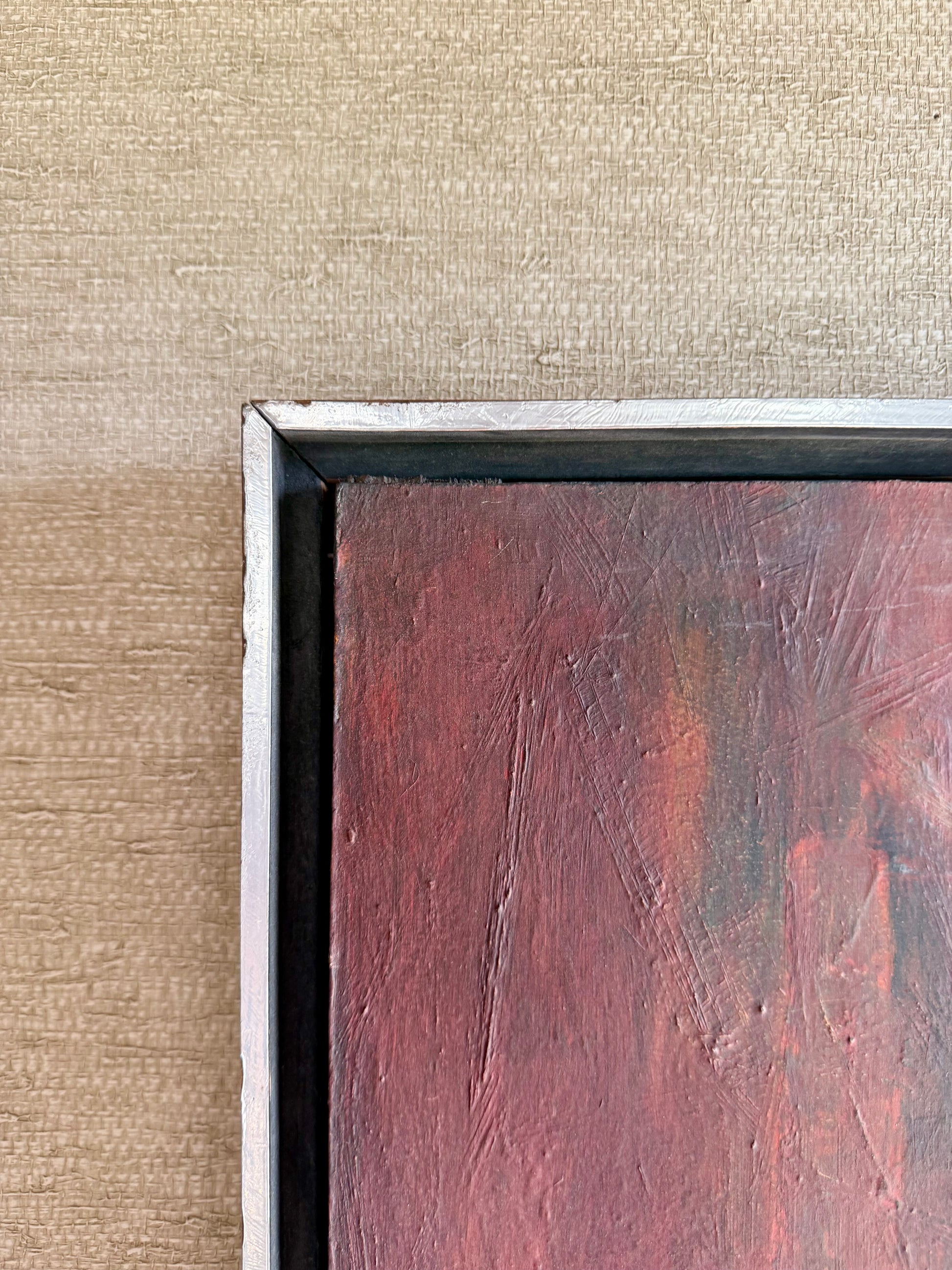 Close-up of an abstract painting with a textured brown background