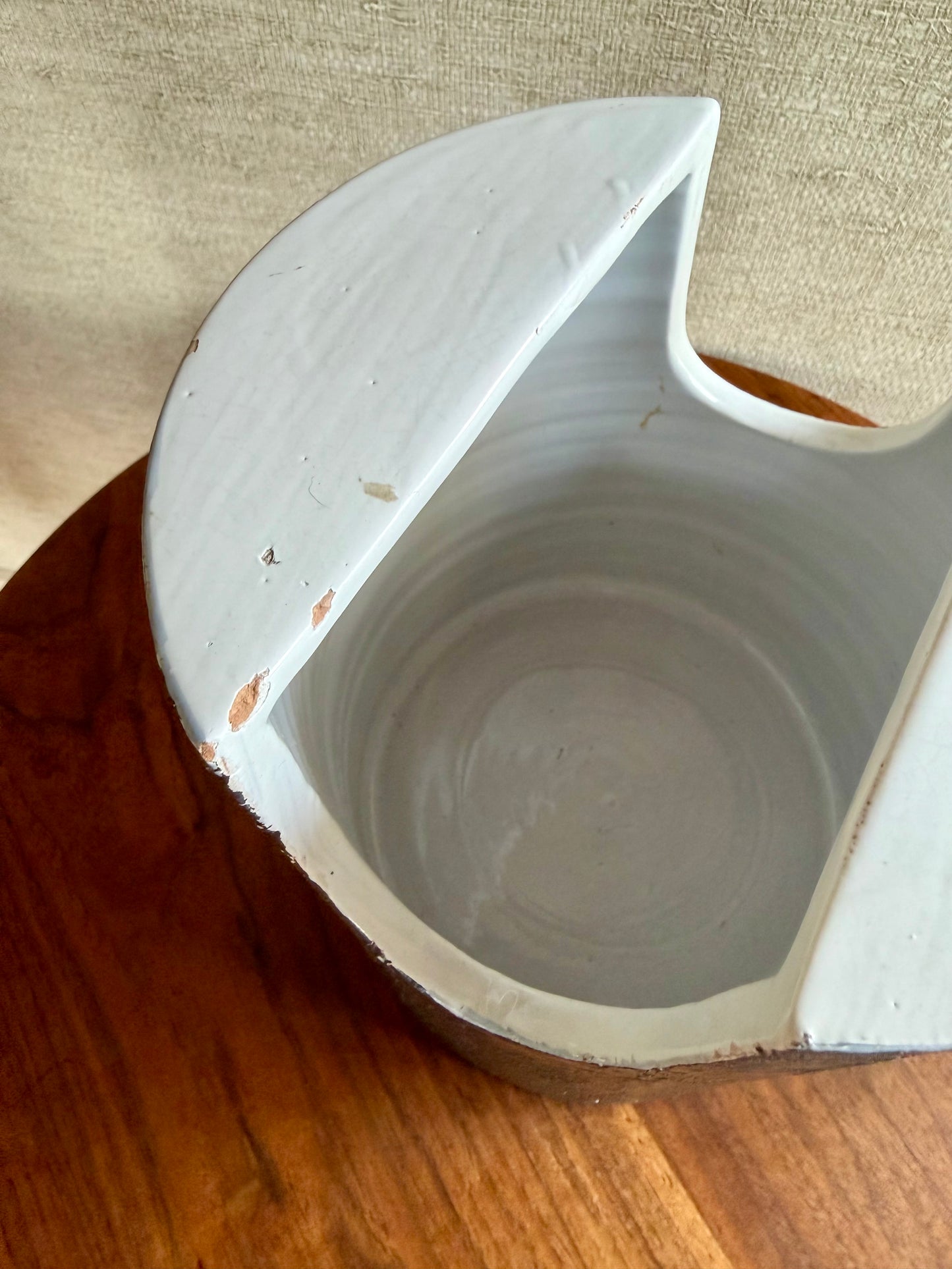Ceramic planter with a unique design on a wooden surface